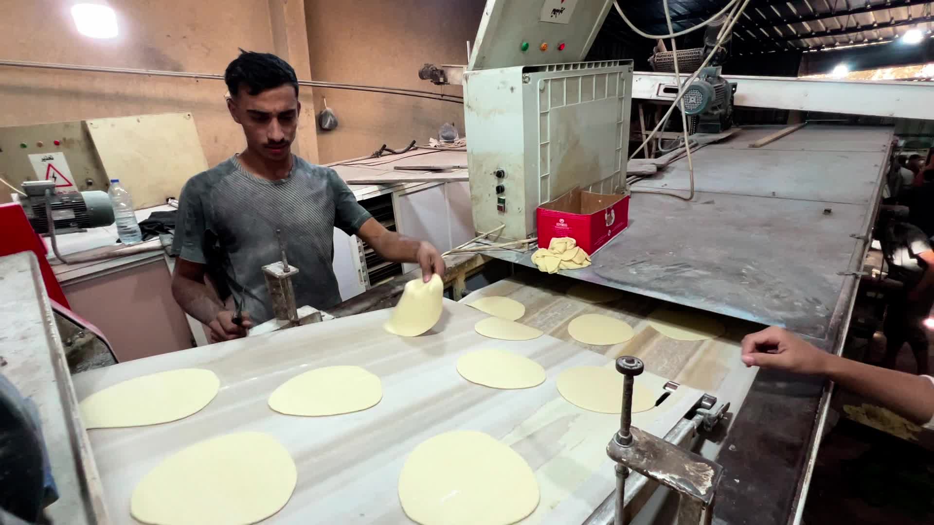 Palestinians Queue for Bread in Khan Yunis Amid Gaza Conflict