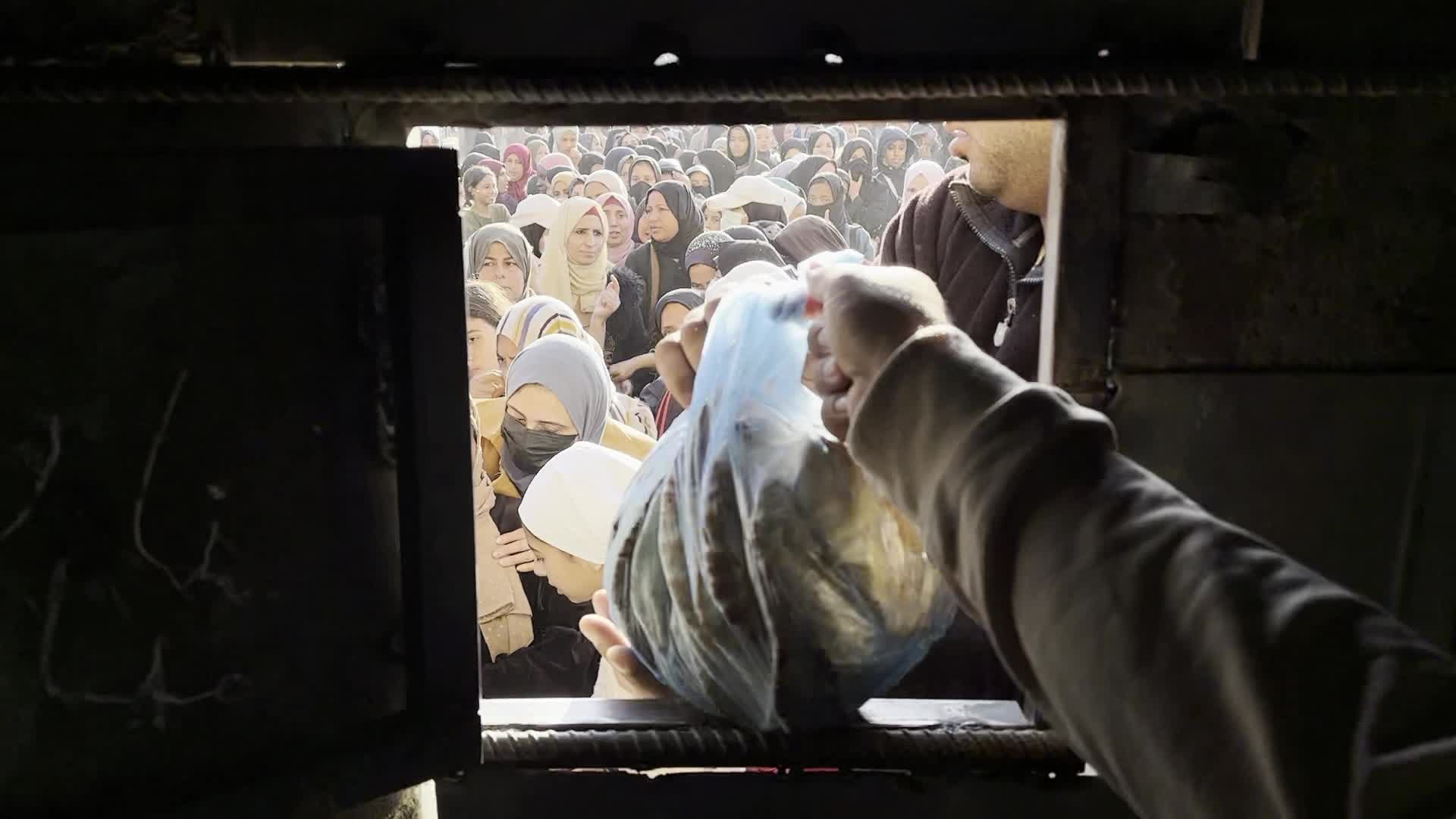 Palestinians Queue for Bread at Bakery in Khan Yunis Amid Gaza Conflict
