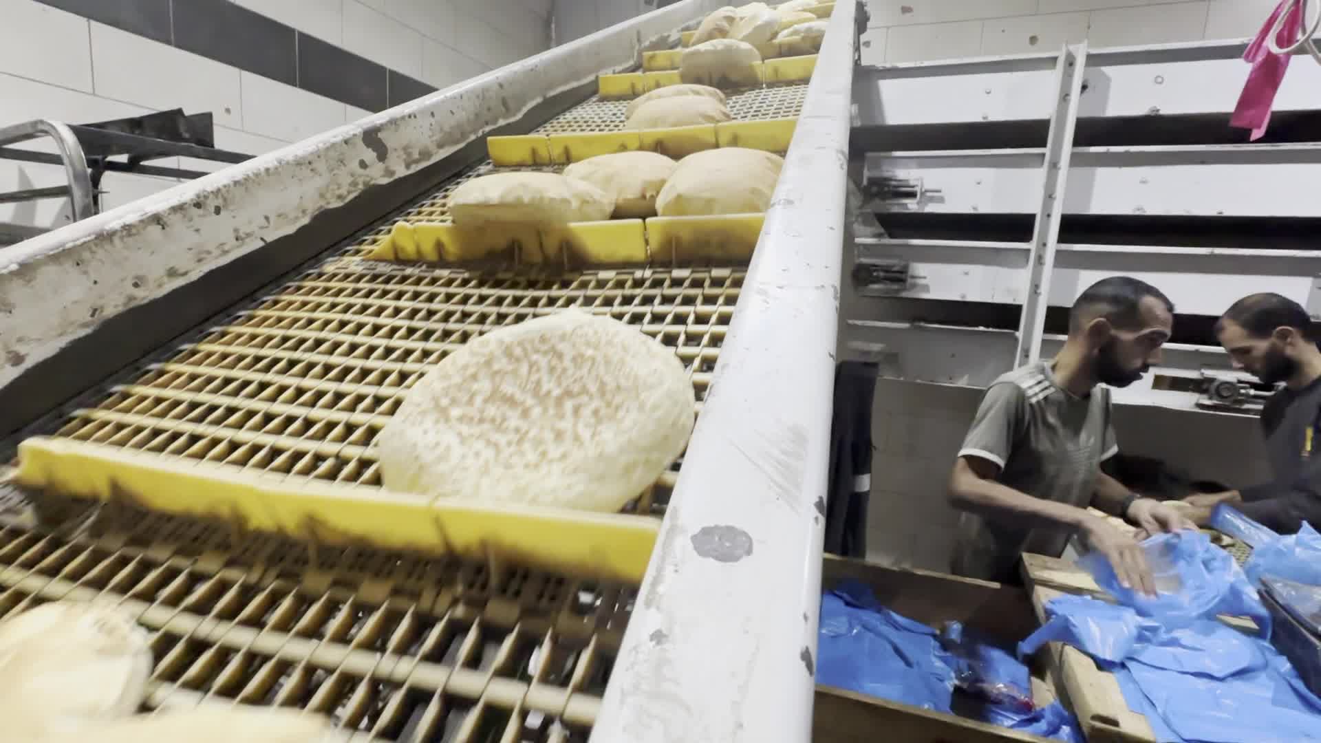 Palestinians Queue for Bread at Bakery in Khan Yunis Amid Gaza Conflict
