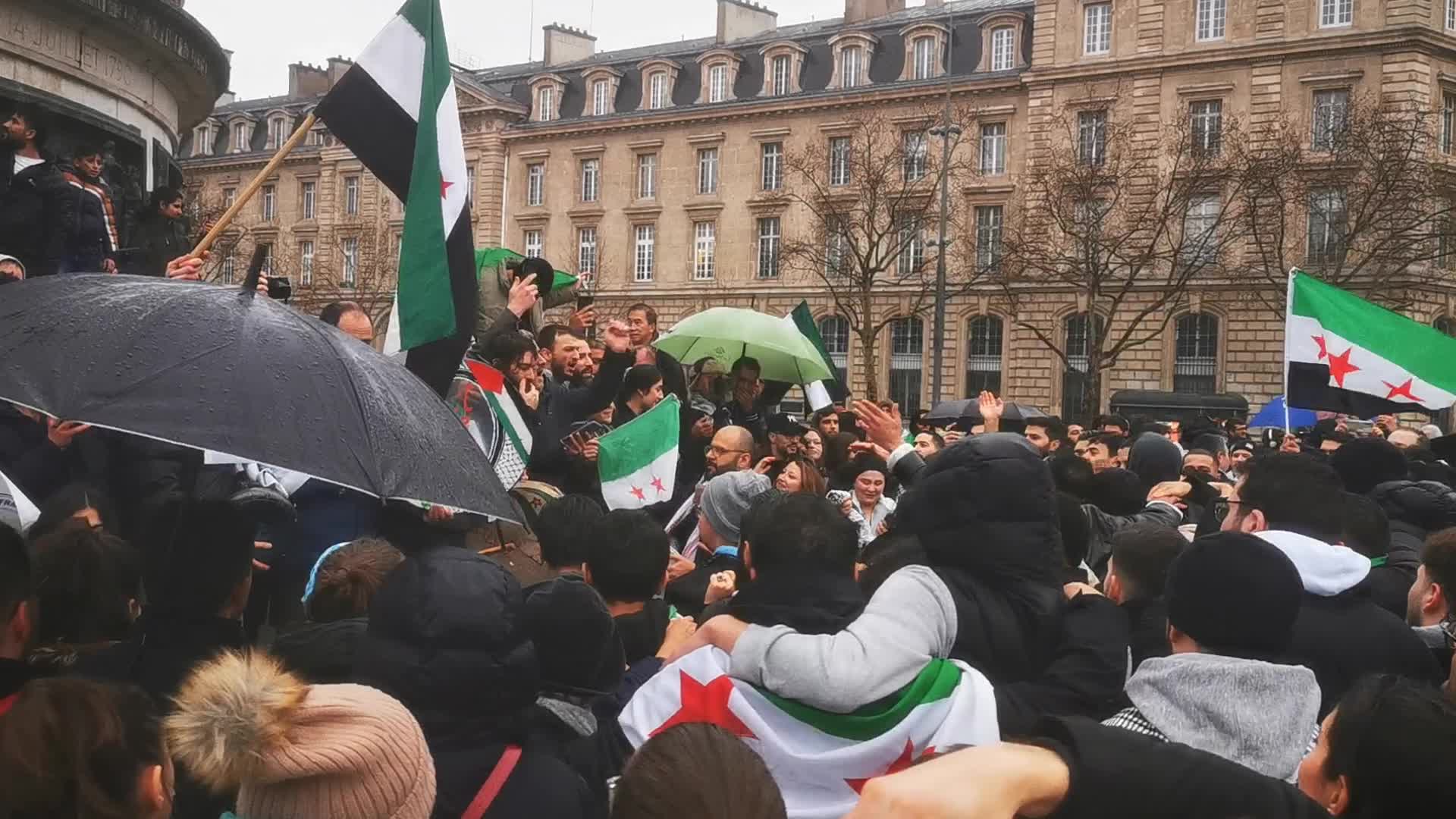 Members of the Syrian community celebrate the fall of Syrian president Bashar al-Assad 