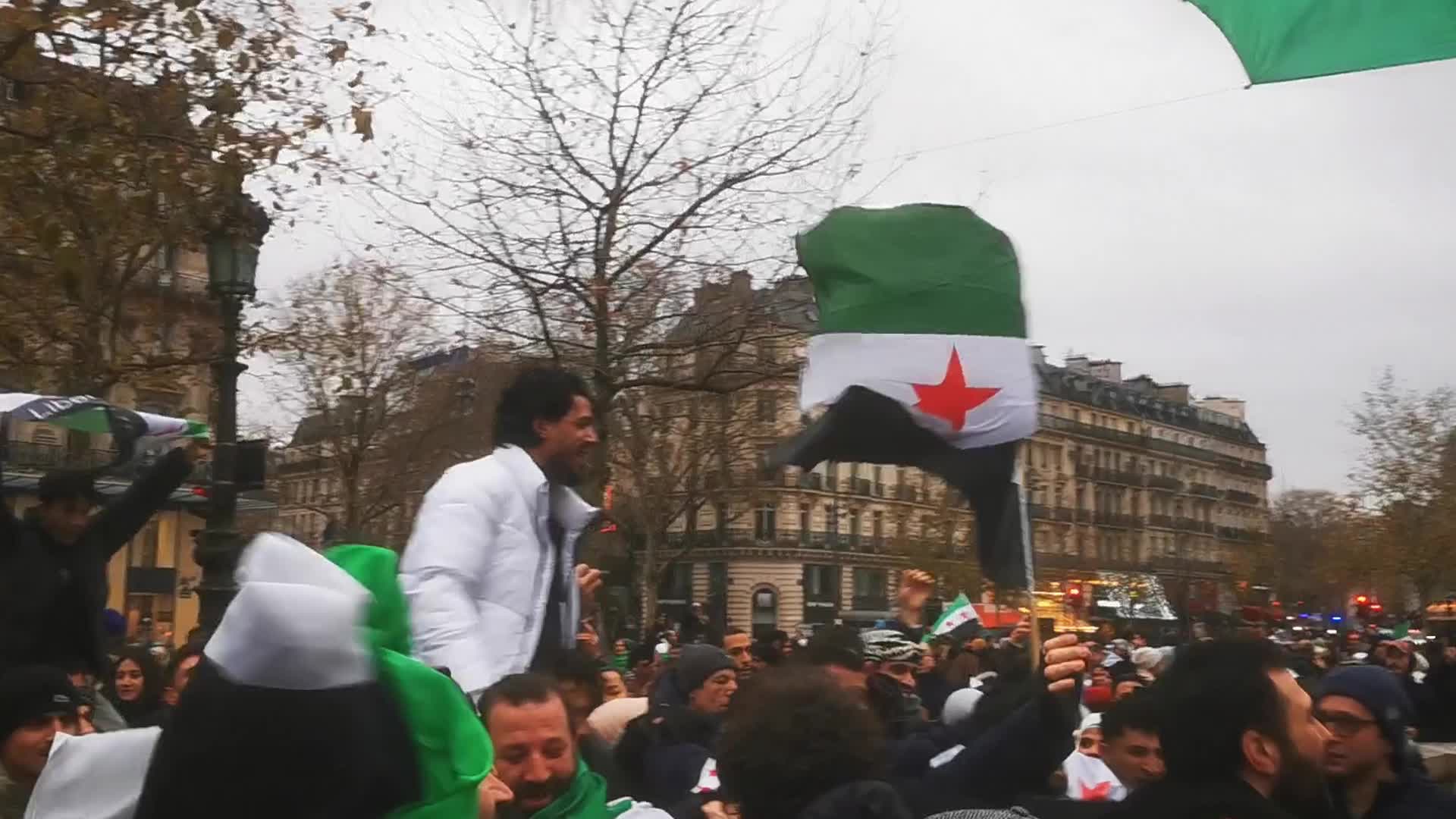 Members of the Syrian community celebrate the fall of Syrian president Bashar al-Assad 