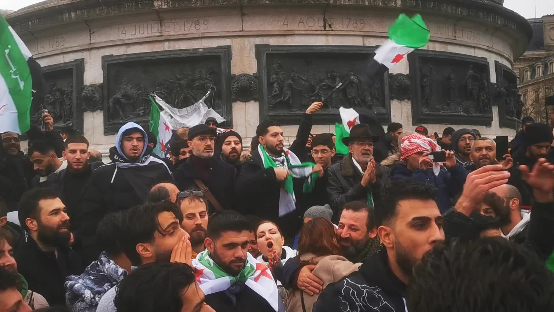 Members of the Syrian community celebrate the fall of Syrian president Bashar al-Assad 