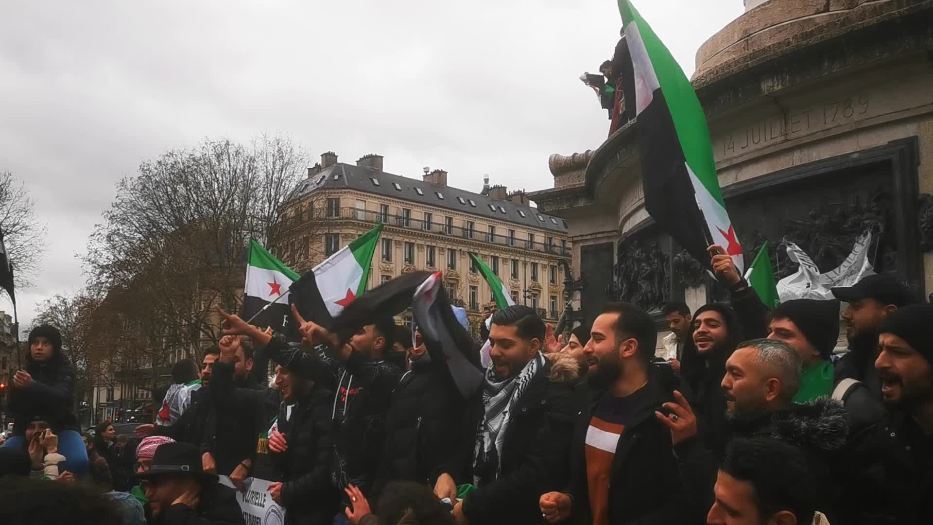 Members of the Syrian community celebrate the fall of Syrian president Bashar al-Assad 