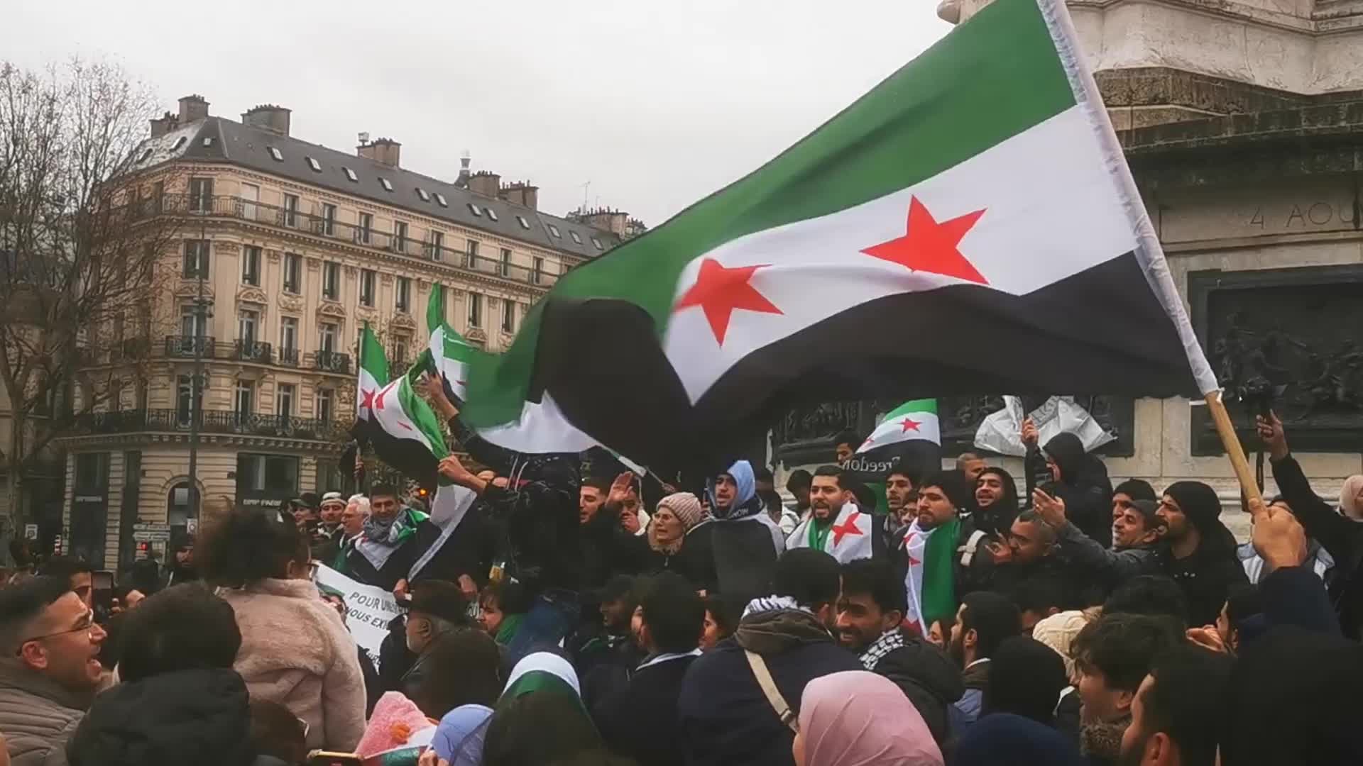 Members of the Syrian community celebrate the fall of Syrian president Bashar al-Assad 