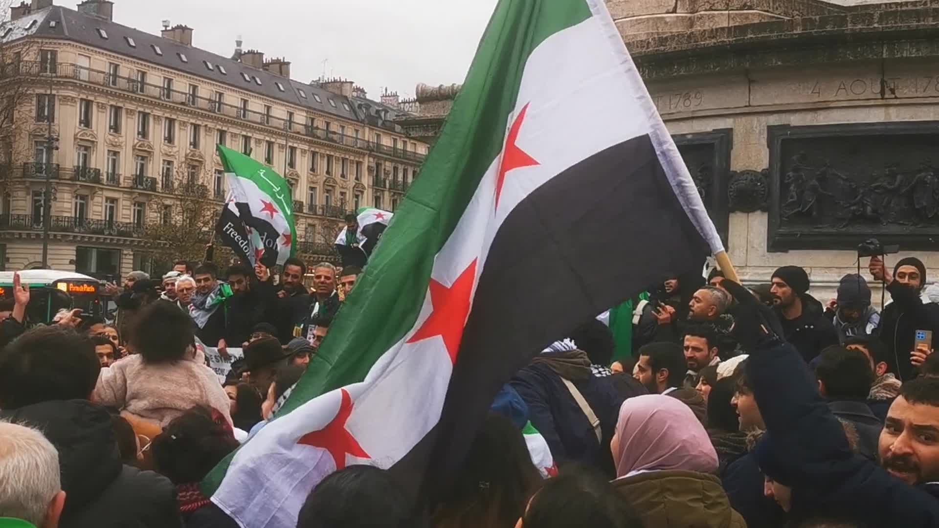 Members of the Syrian community celebrate the fall of Syrian president Bashar al-Assad 