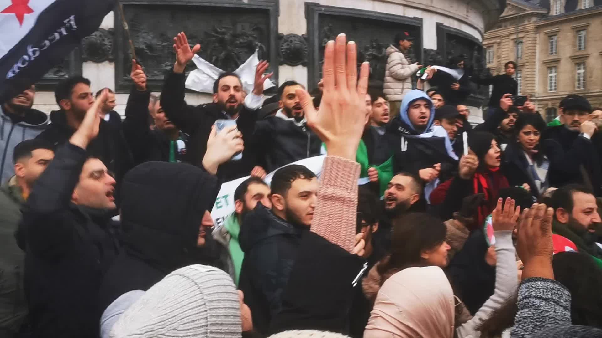 Members of the Syrian community celebrate the fall of Syrian president Bashar al-Assad 