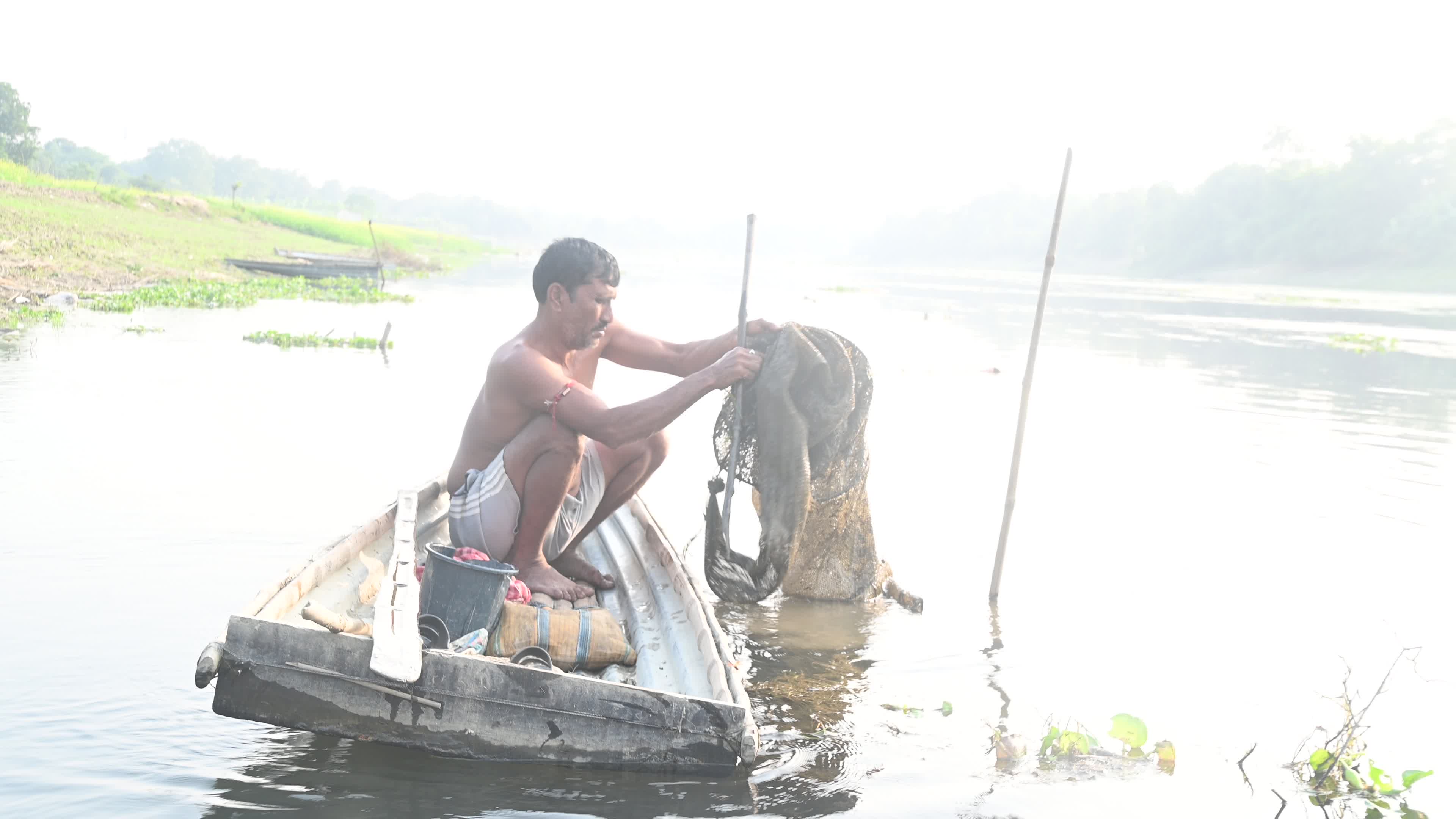 Fisherman catches fish from the river
