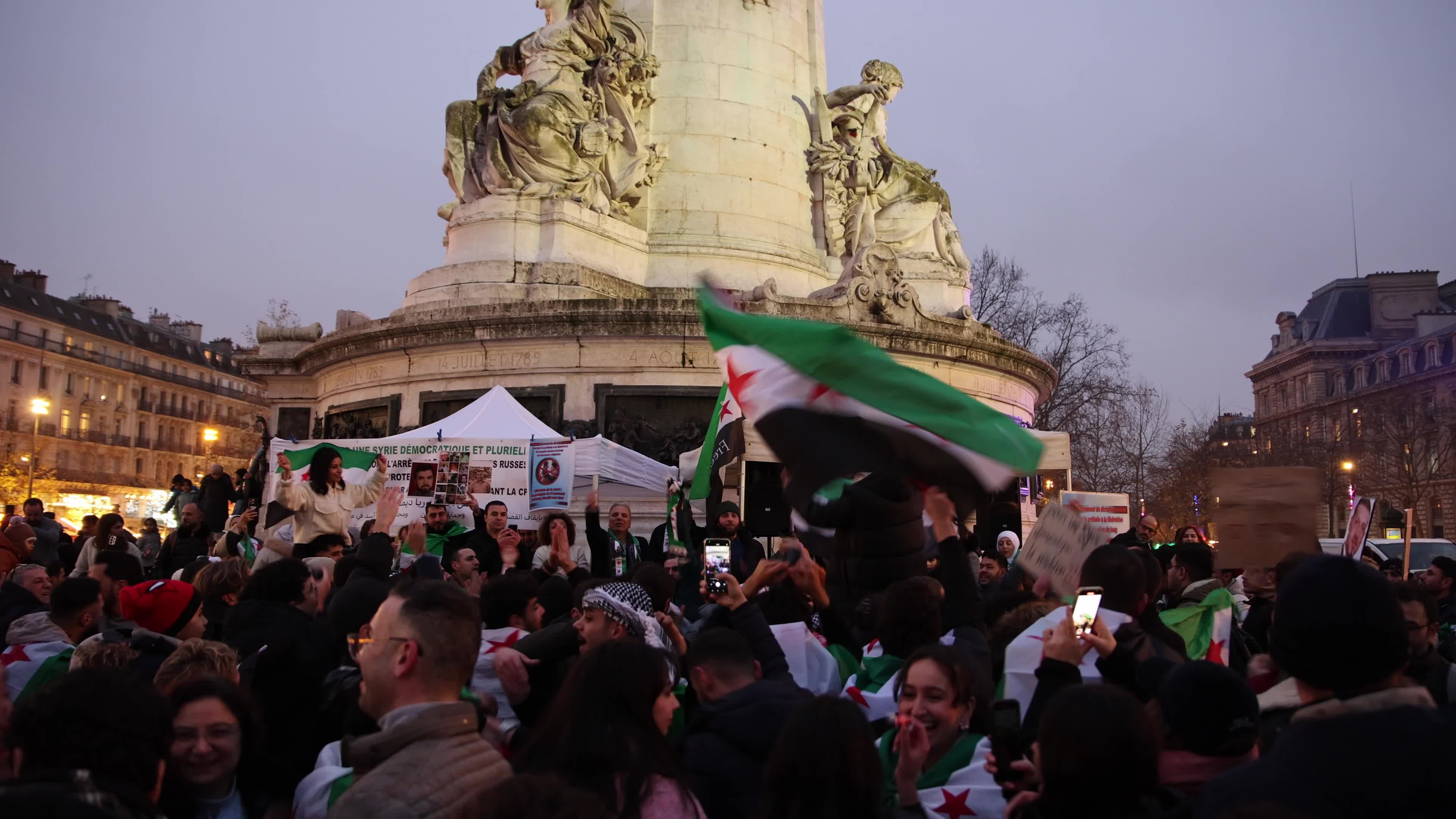 Members of the Syrian community celebrate the fall of Syrian president Bashar al-Assad
