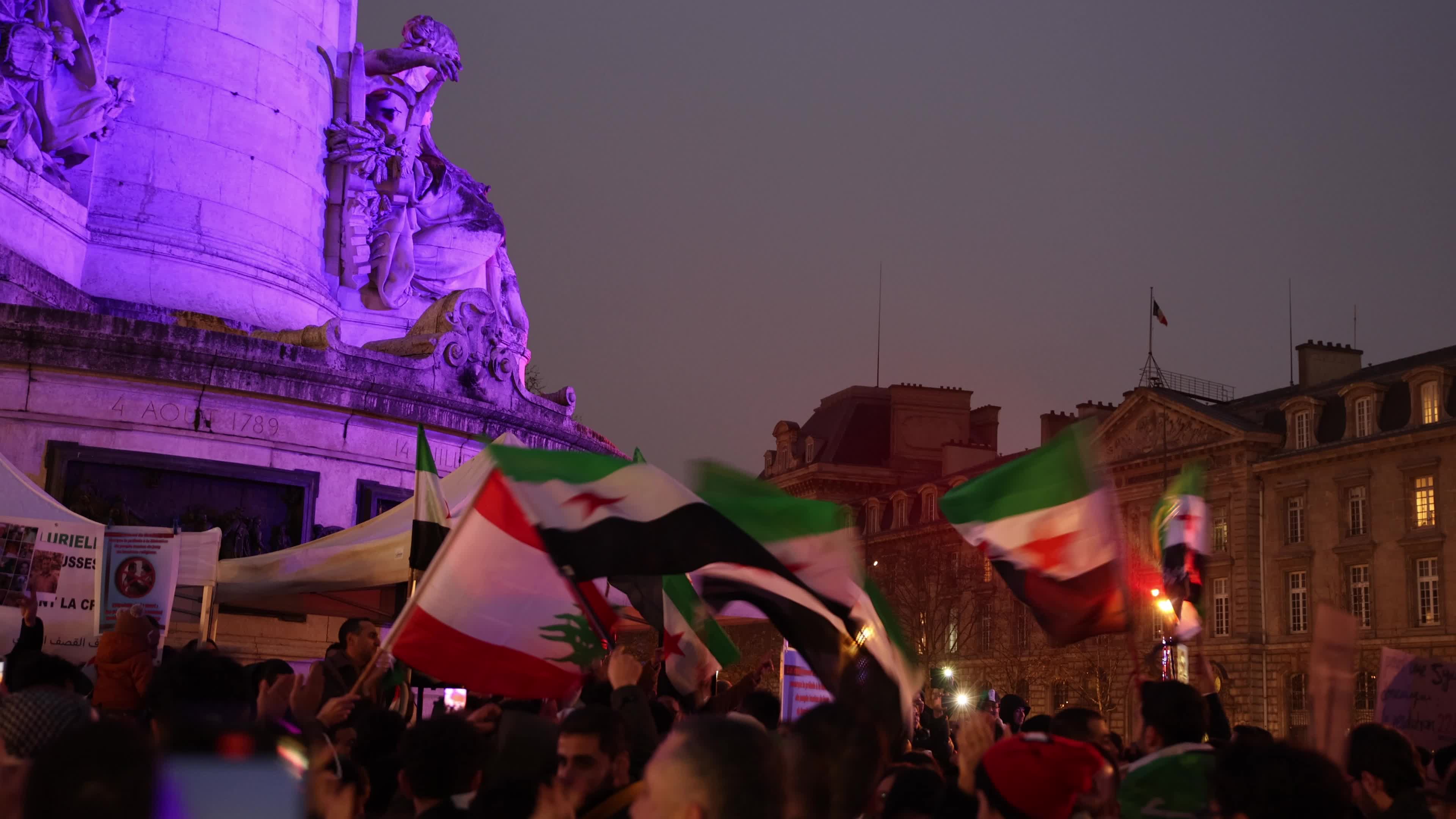 Members of the Syrian community celebrate the fall of Syrian president Bashar al-Assad