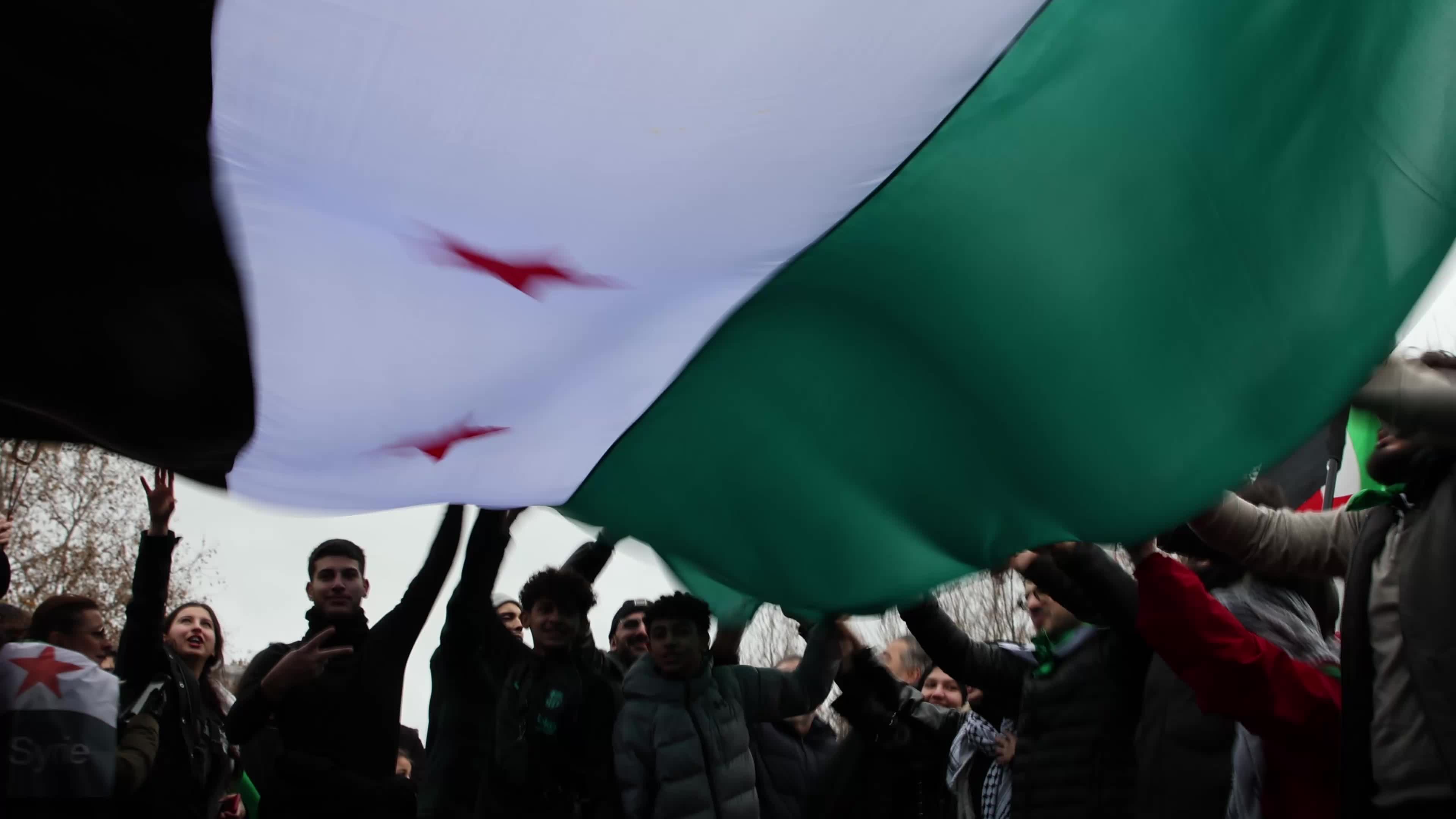 Members of the Syrian community celebrate the fall of Syrian president Bashar al-Assad