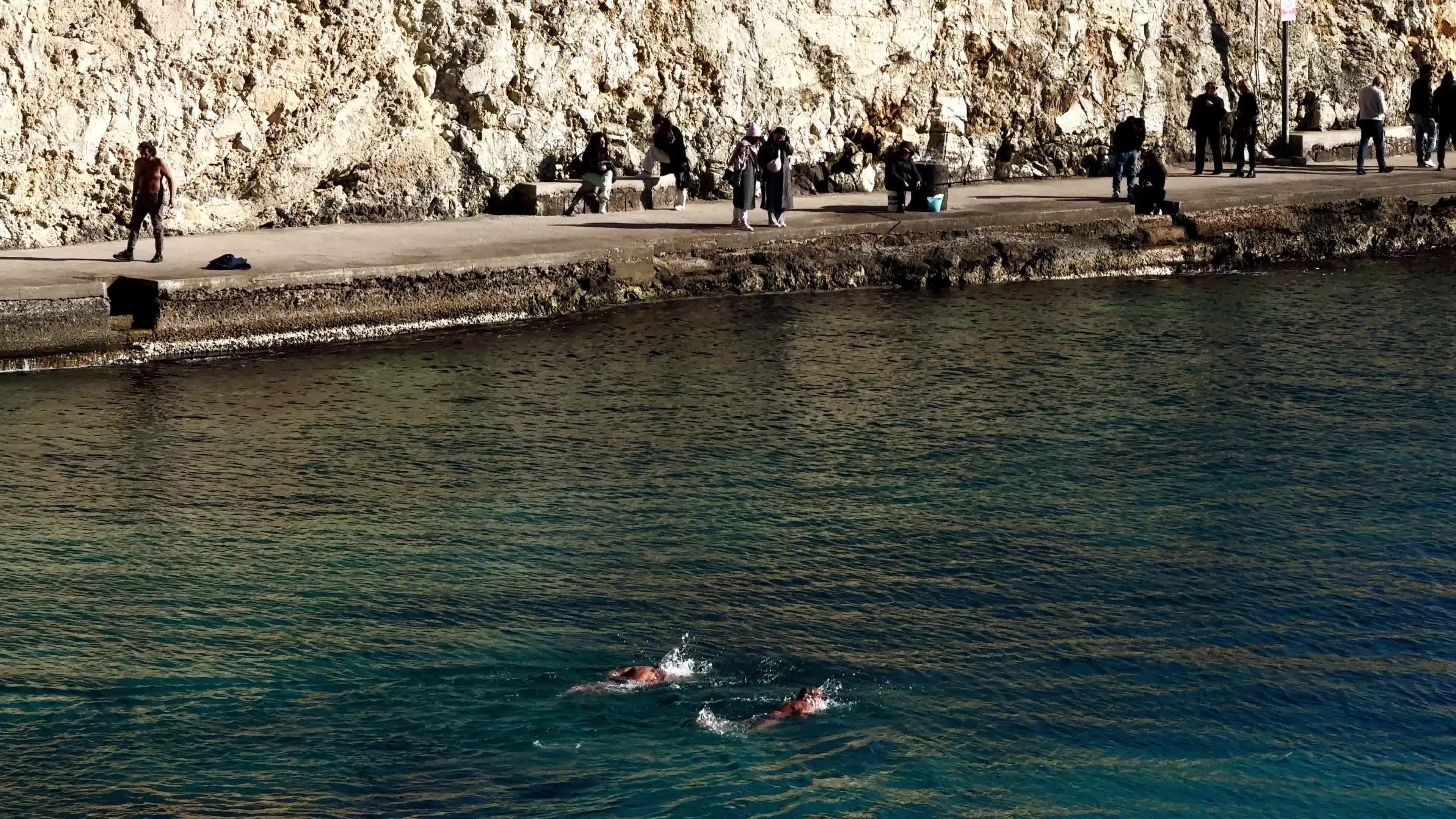 Swimmers Enjoy the Sea in Tricase Porto Amid Mild Winter Weather