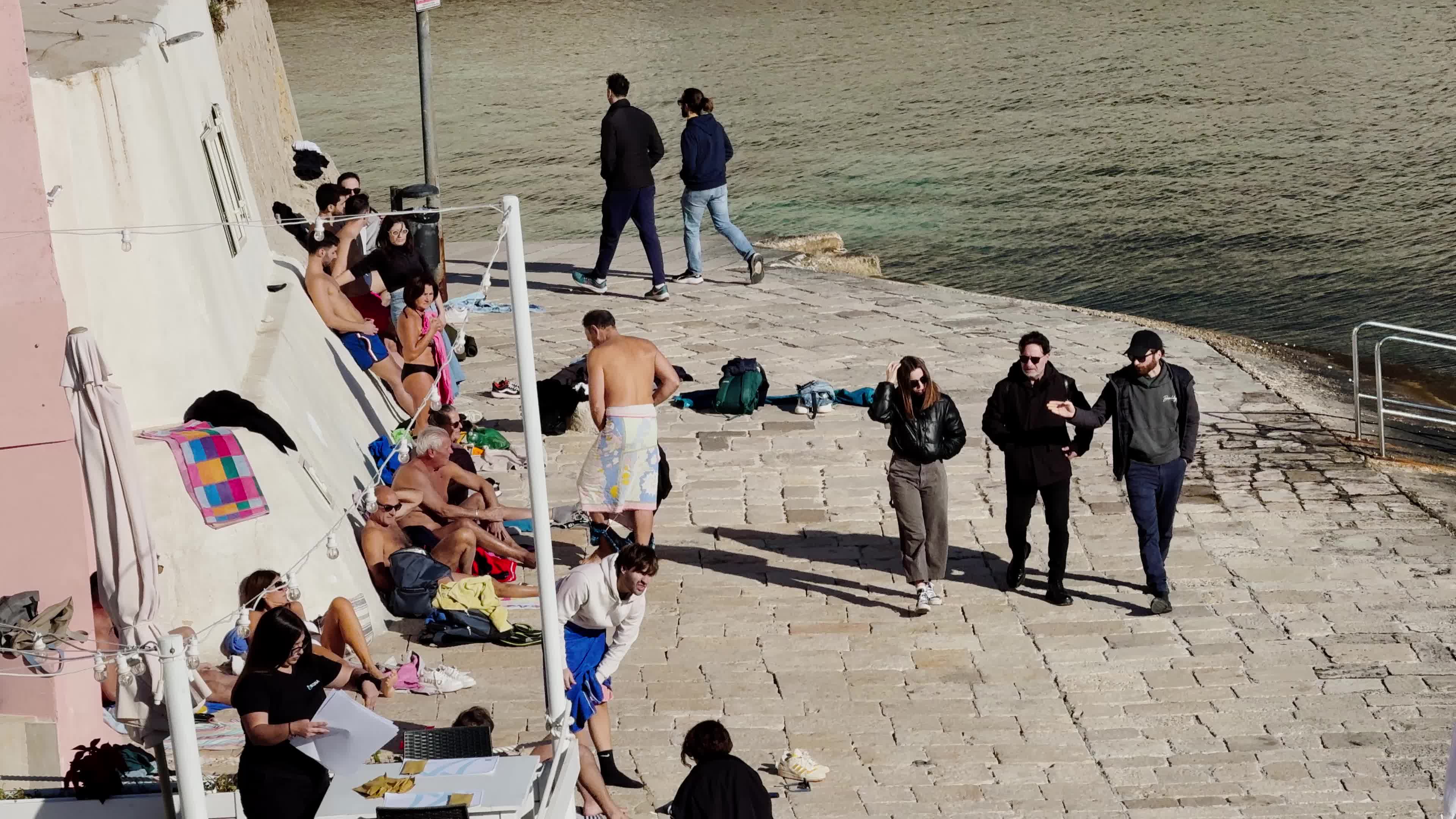 Swimmers Enjoy the Sea in Tricase Porto Amid Mild Winter Weather