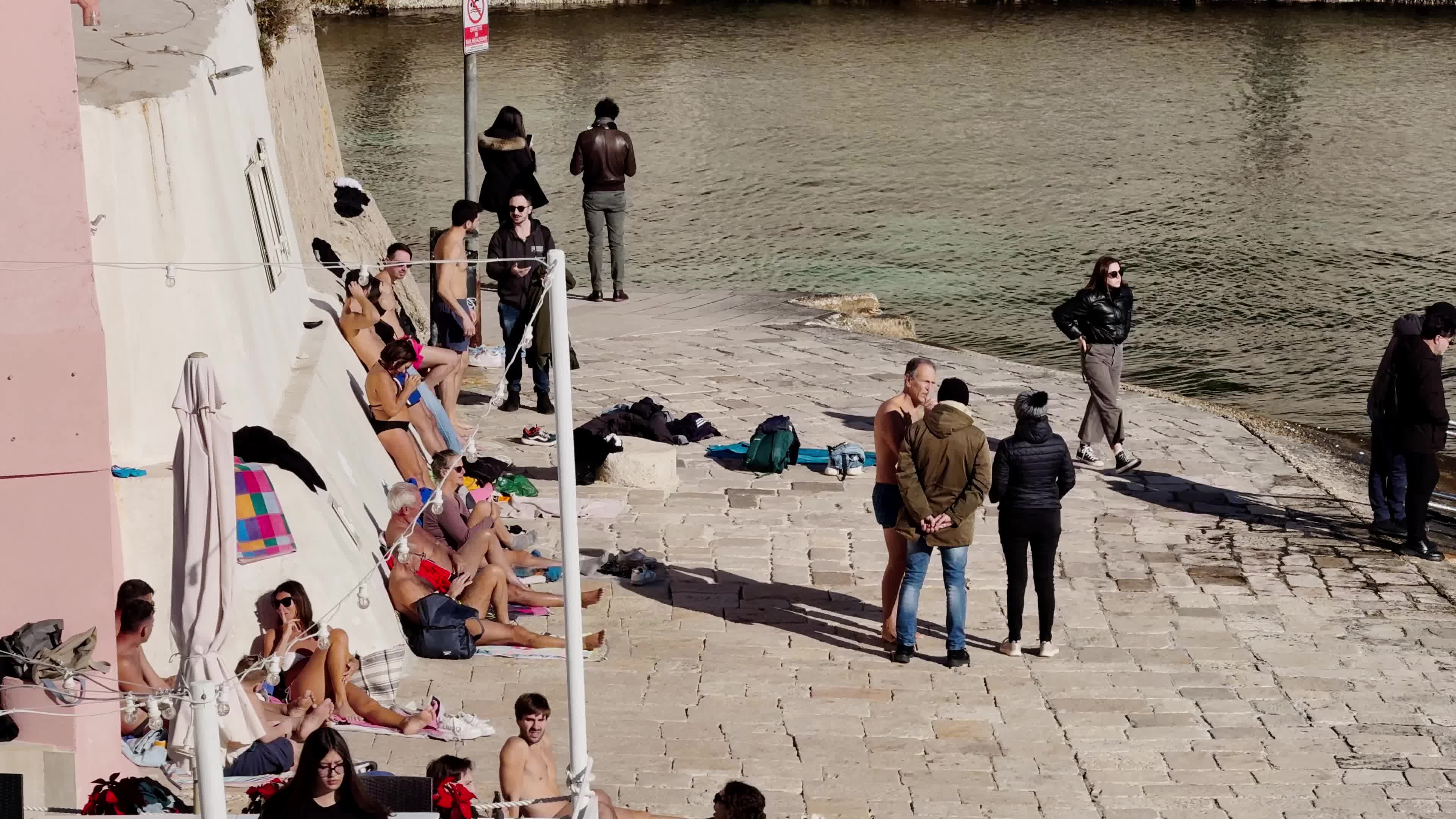 Swimmers Enjoy the Sea in Tricase Porto Amid Mild Winter Weather