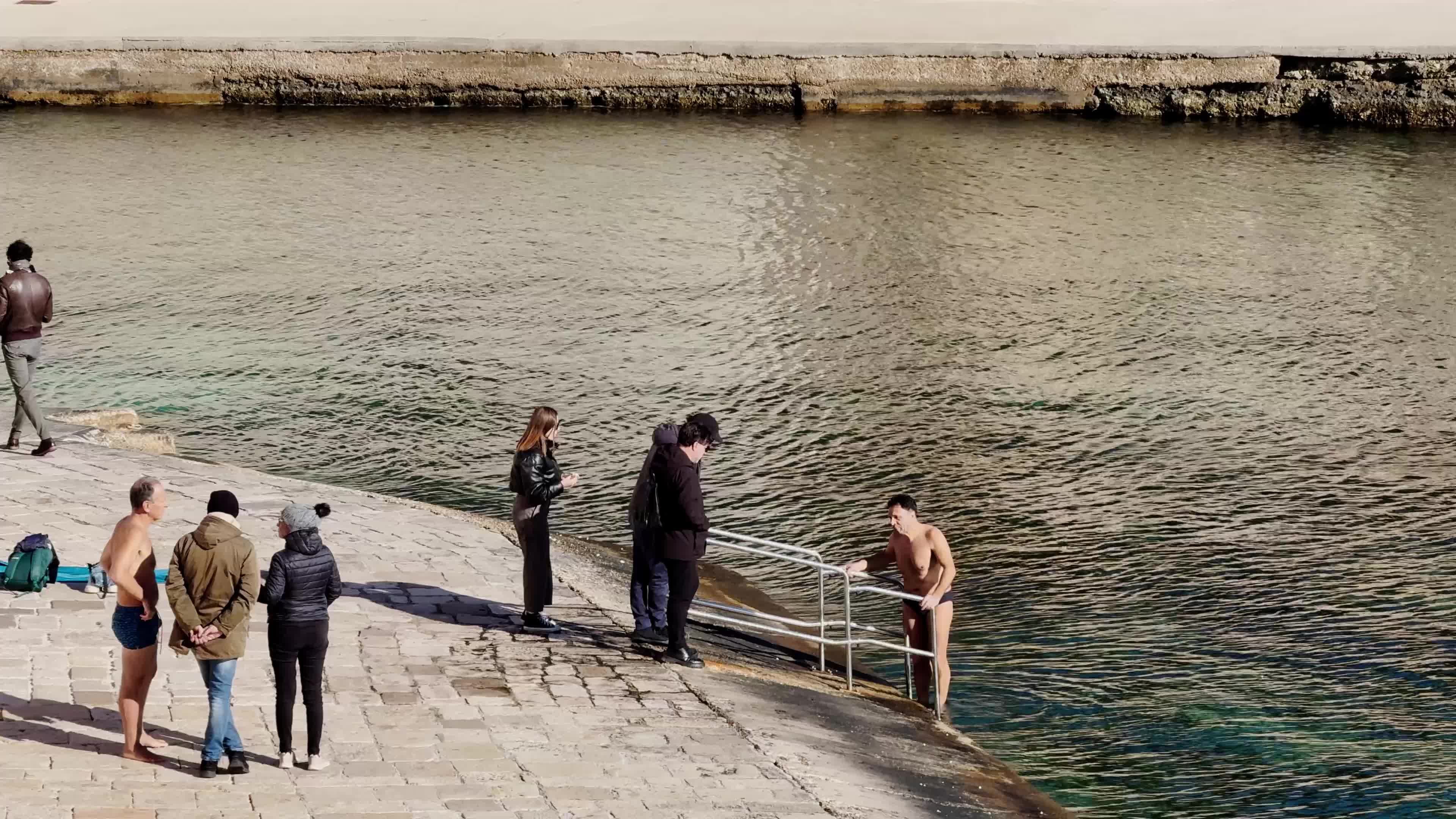 Swimmers Enjoy the Sea in Tricase Porto Amid Mild Winter Weather