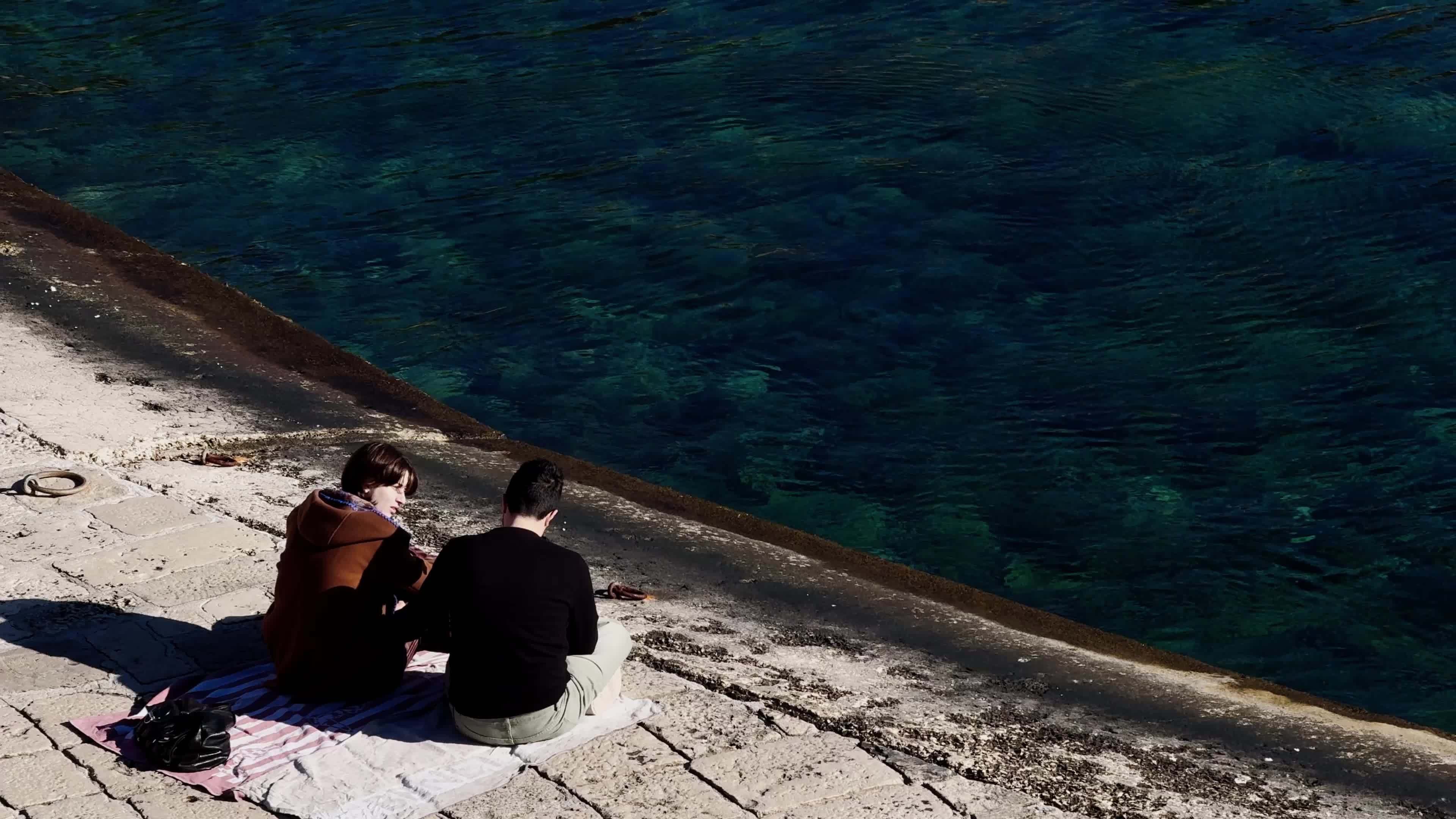 Swimmers Enjoy the Sea in Tricase Porto Amid Mild Winter Weather