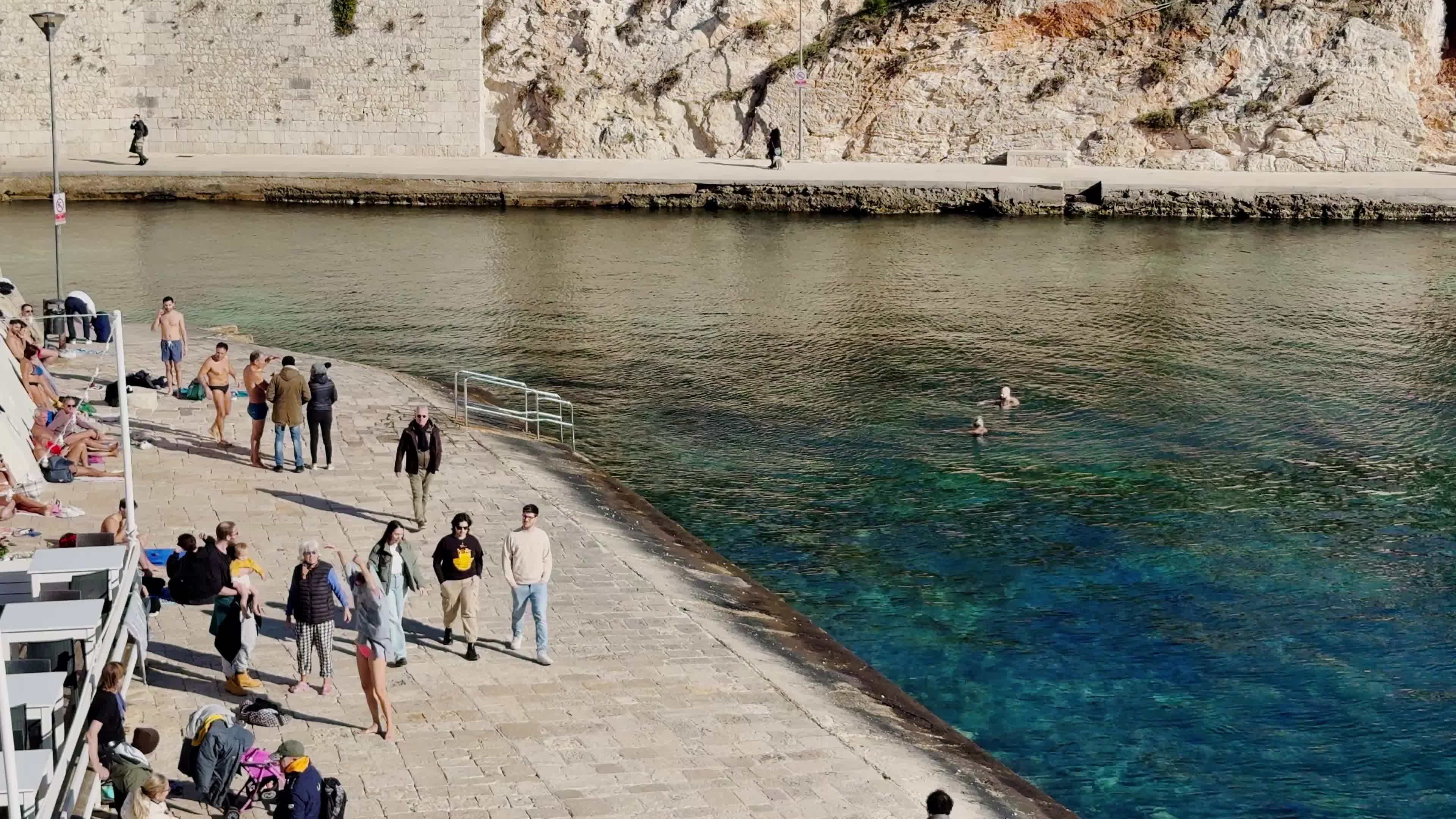 Swimmers Enjoy the Sea in Tricase Porto Amid Mild Winter Weather