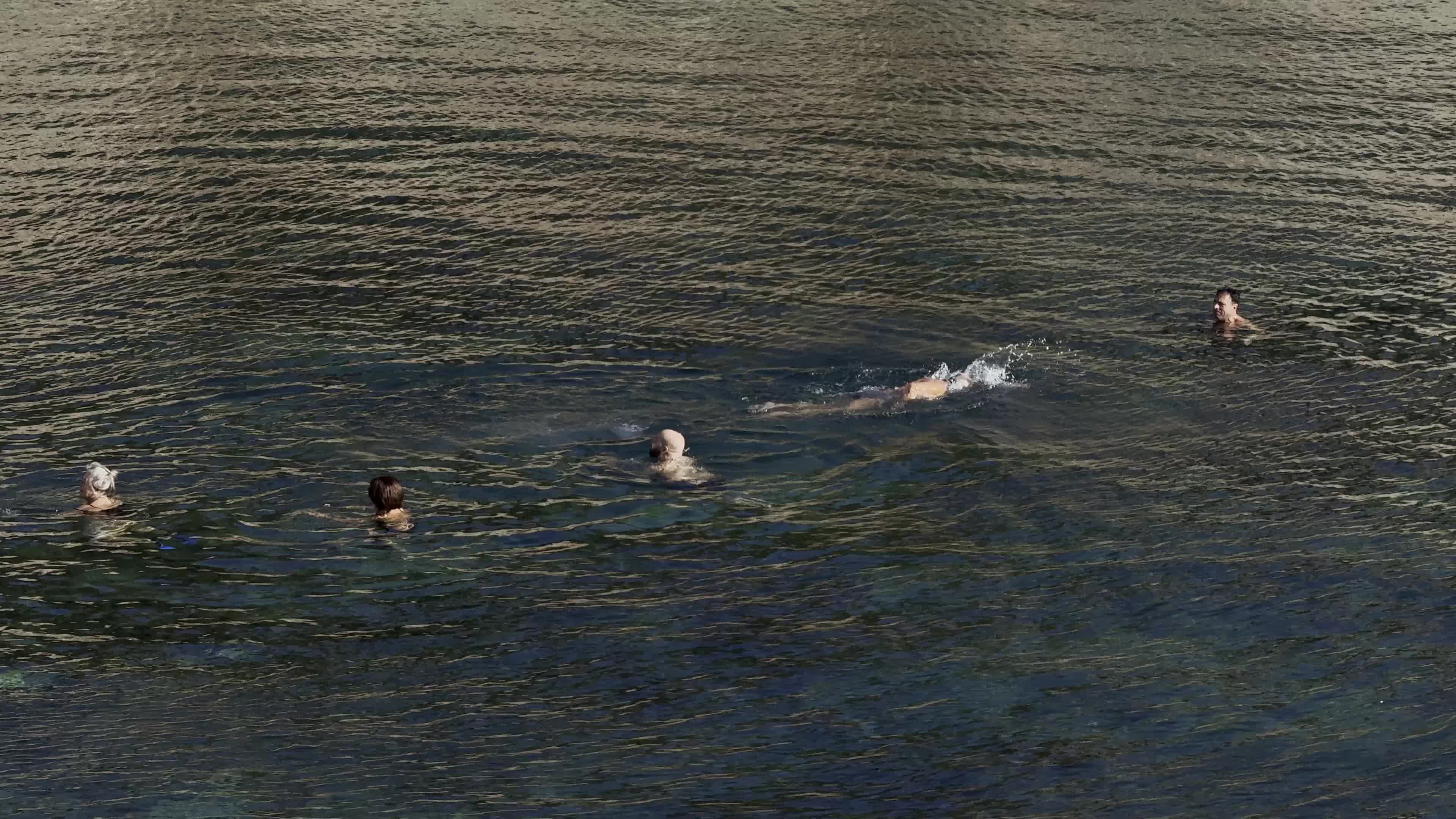 Swimmers Enjoy the Sea in Tricase Porto Amid Mild Winter Weather