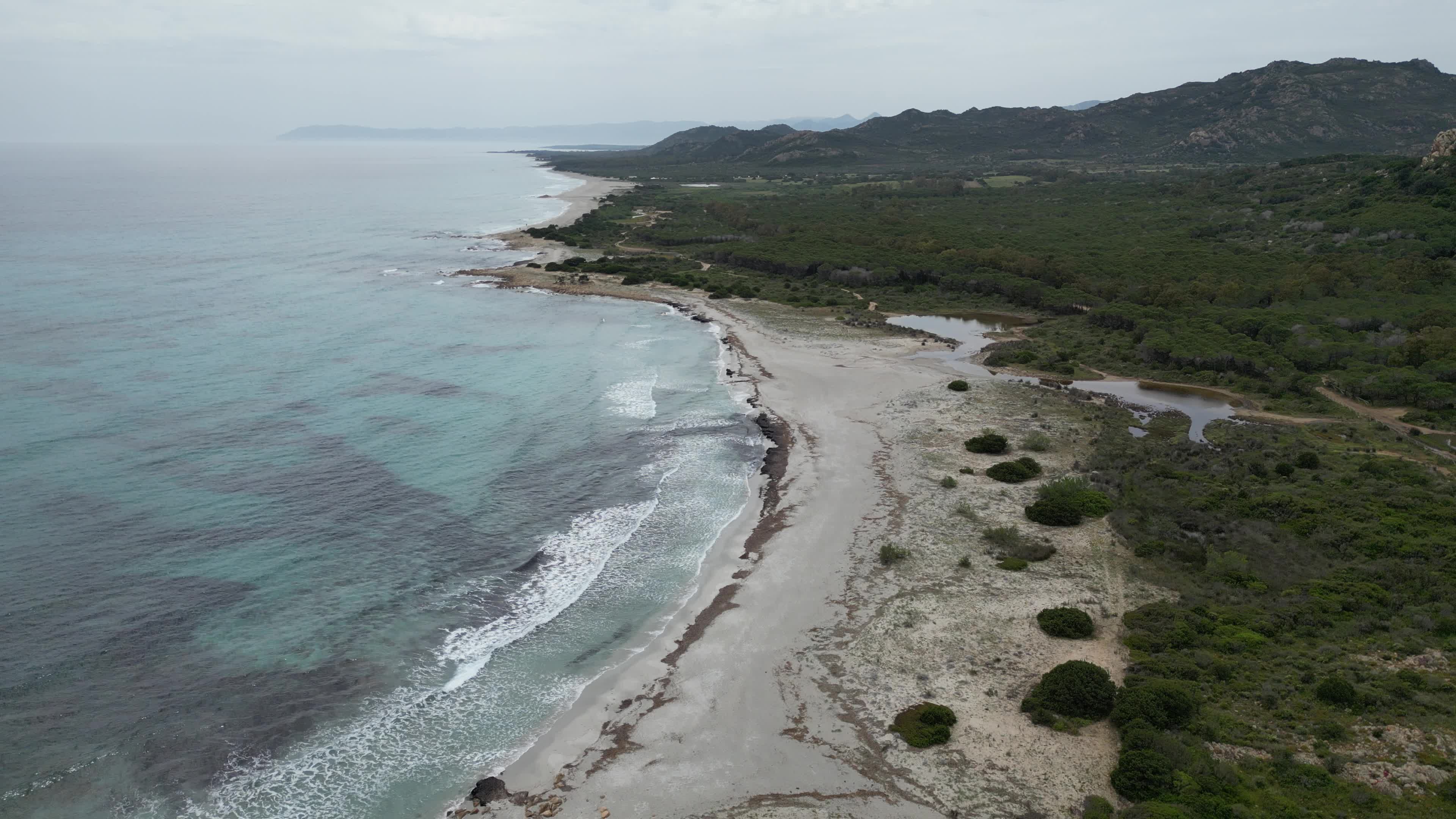 Drone view of Berchida Beach and the protected area surrounding it