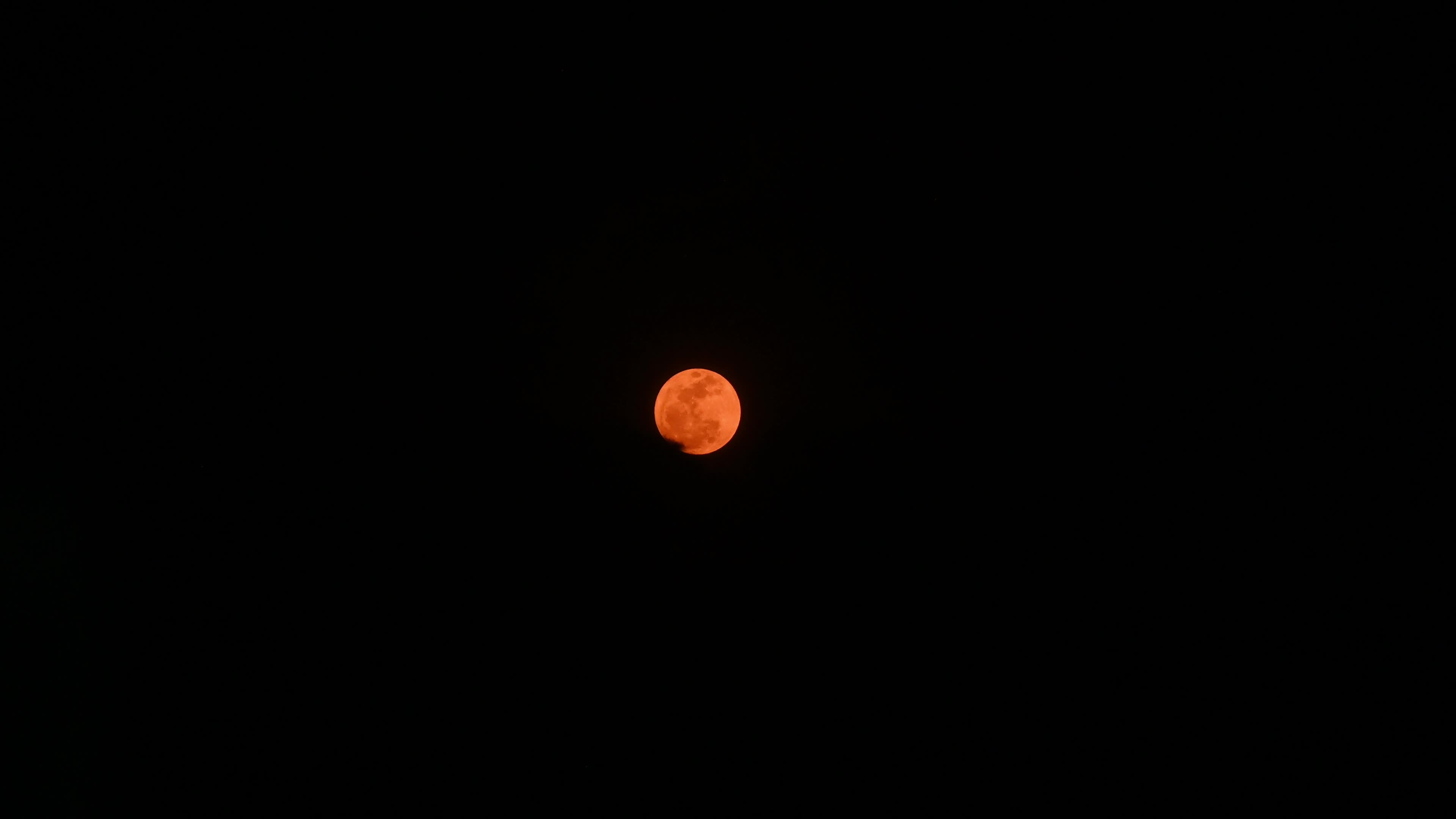 May Flower Moon Lights Up Between Black clouds