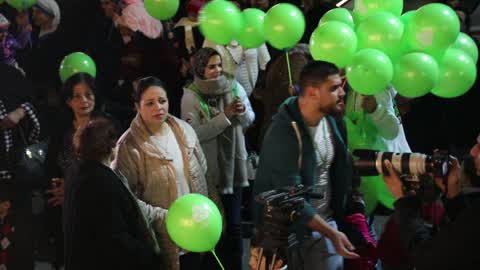 Palestinian Christians attend a Christmas tree lighting celebration