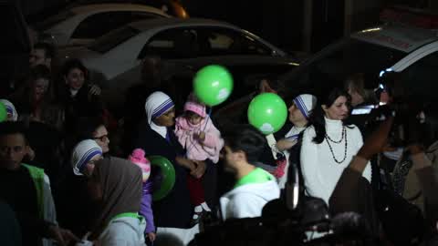 Palestinian Christians attend a Christmas tree lighting celebration