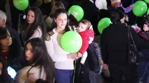 Palestinian Christians attend a Christmas tree lighting celebration