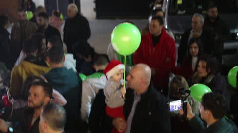 Palestinian Christians attend a Christmas tree lighting celebration
