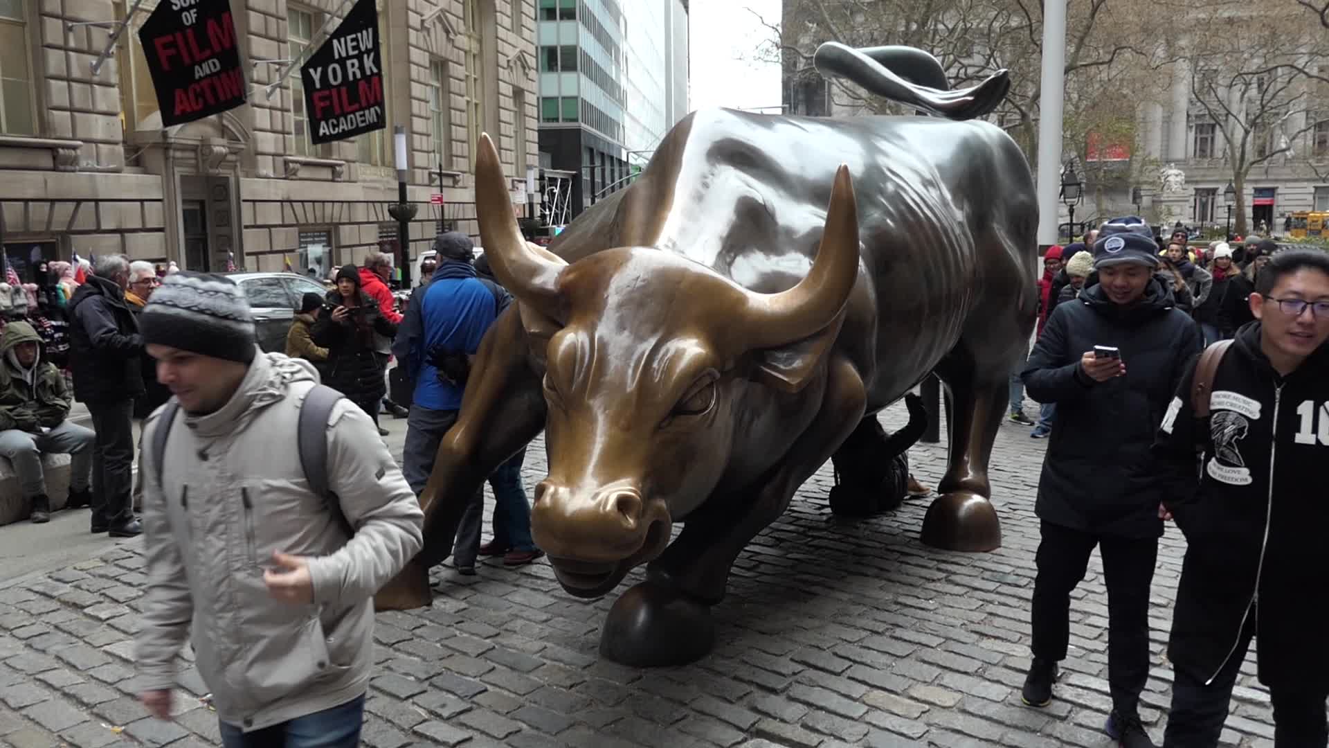 Charging Bull with tourists in NY 