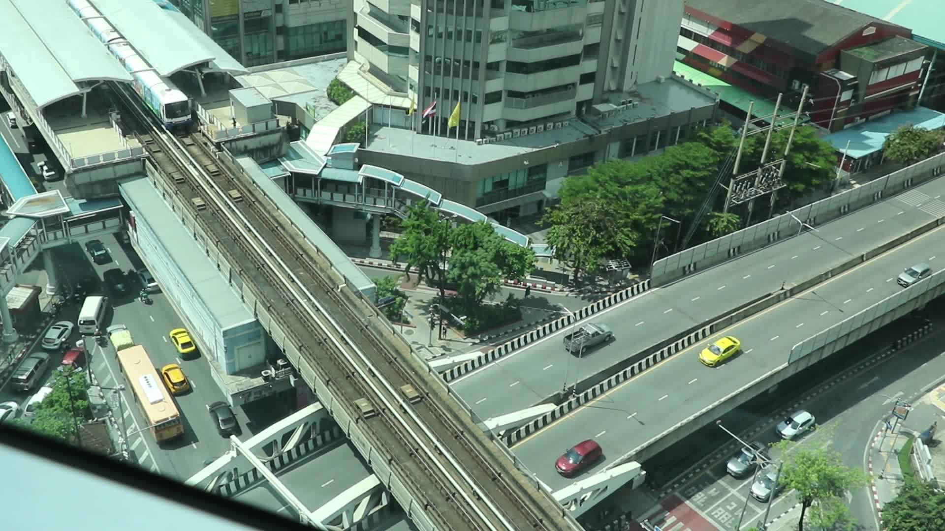 Skytrain drive past buildings in Bangkok.