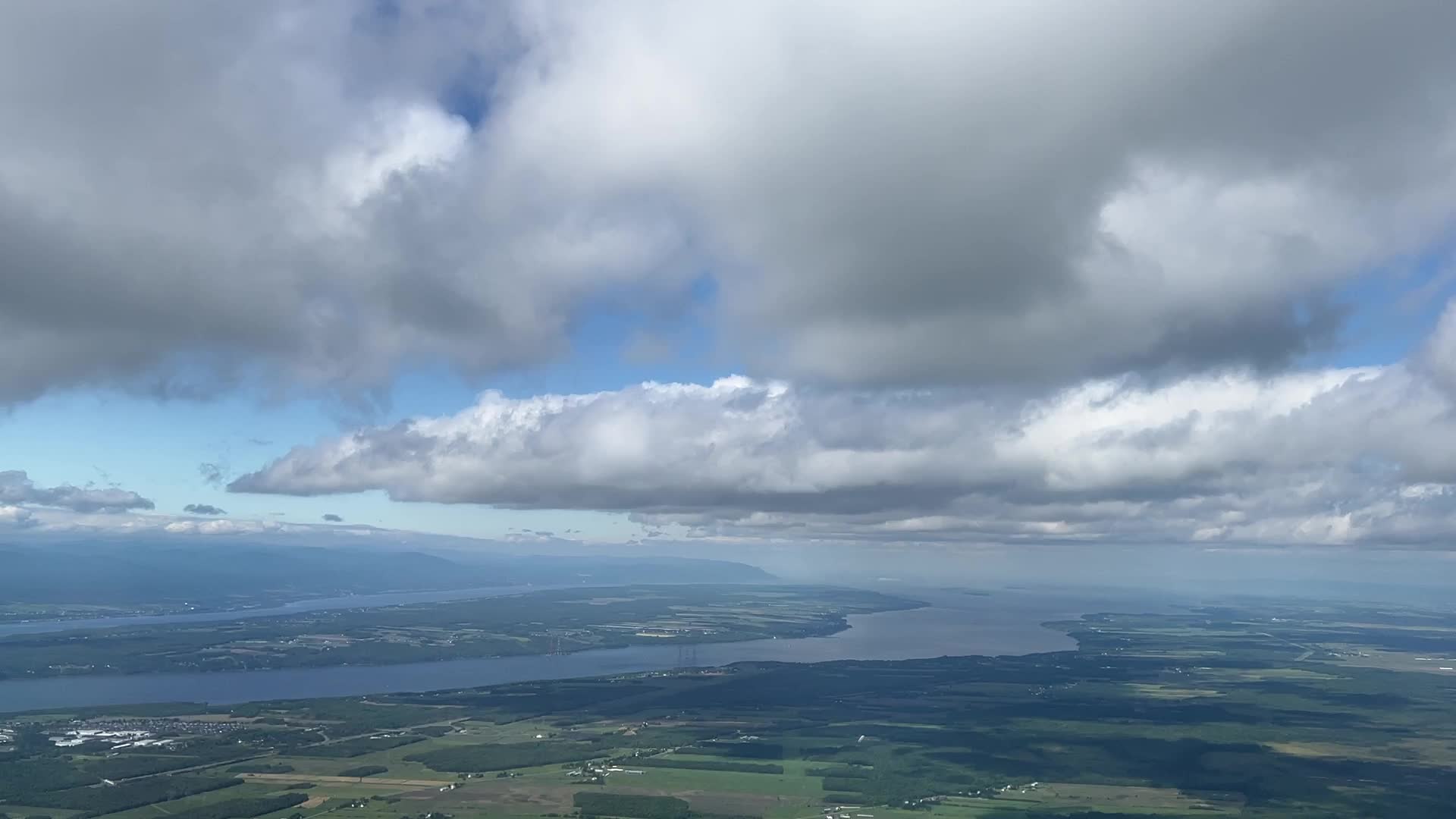 Elevated view above the clouds flying over Quebec, Canada