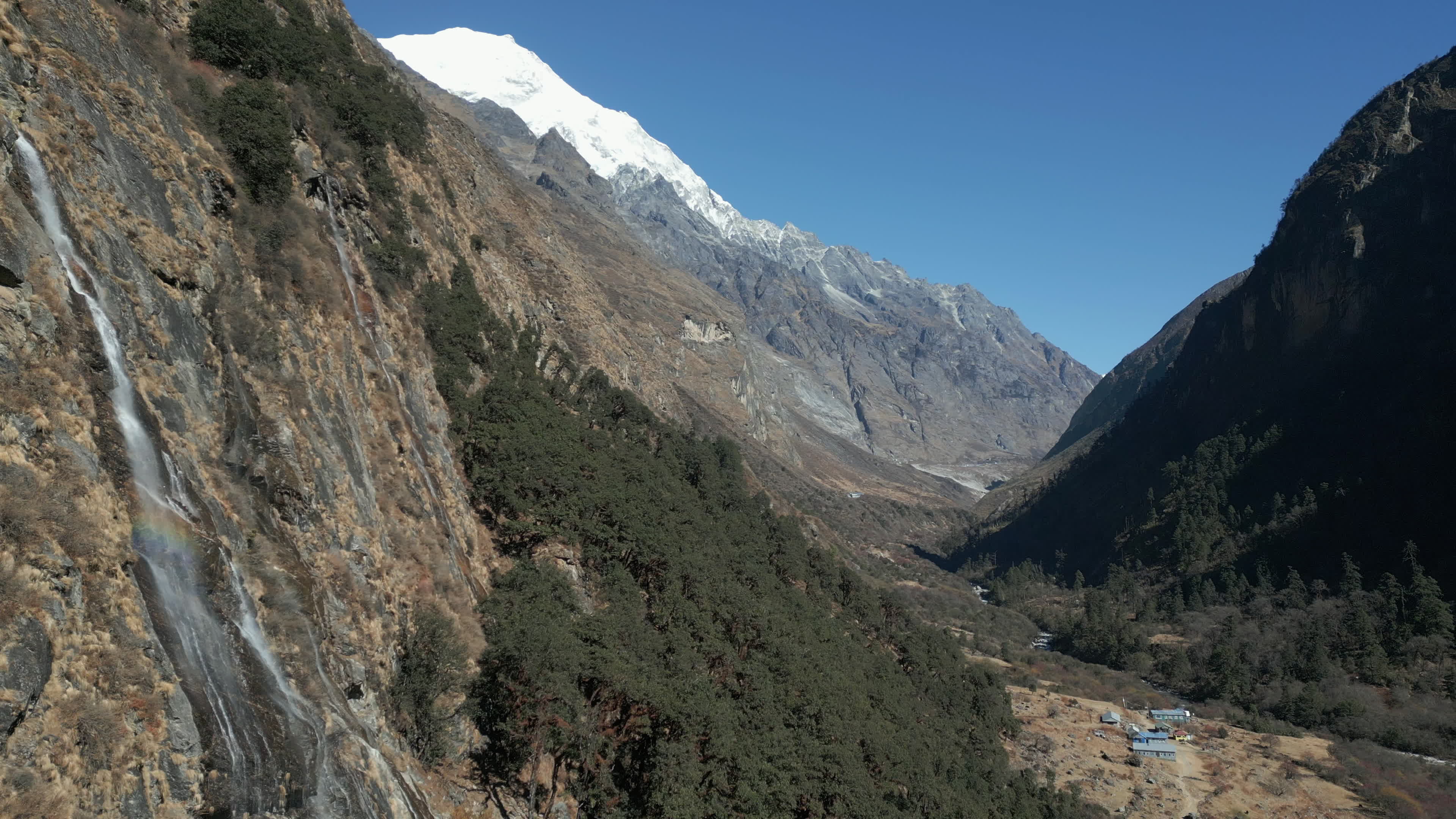 Himalayan Langtang Valley With Waterfall and Snow-Capped Mountain