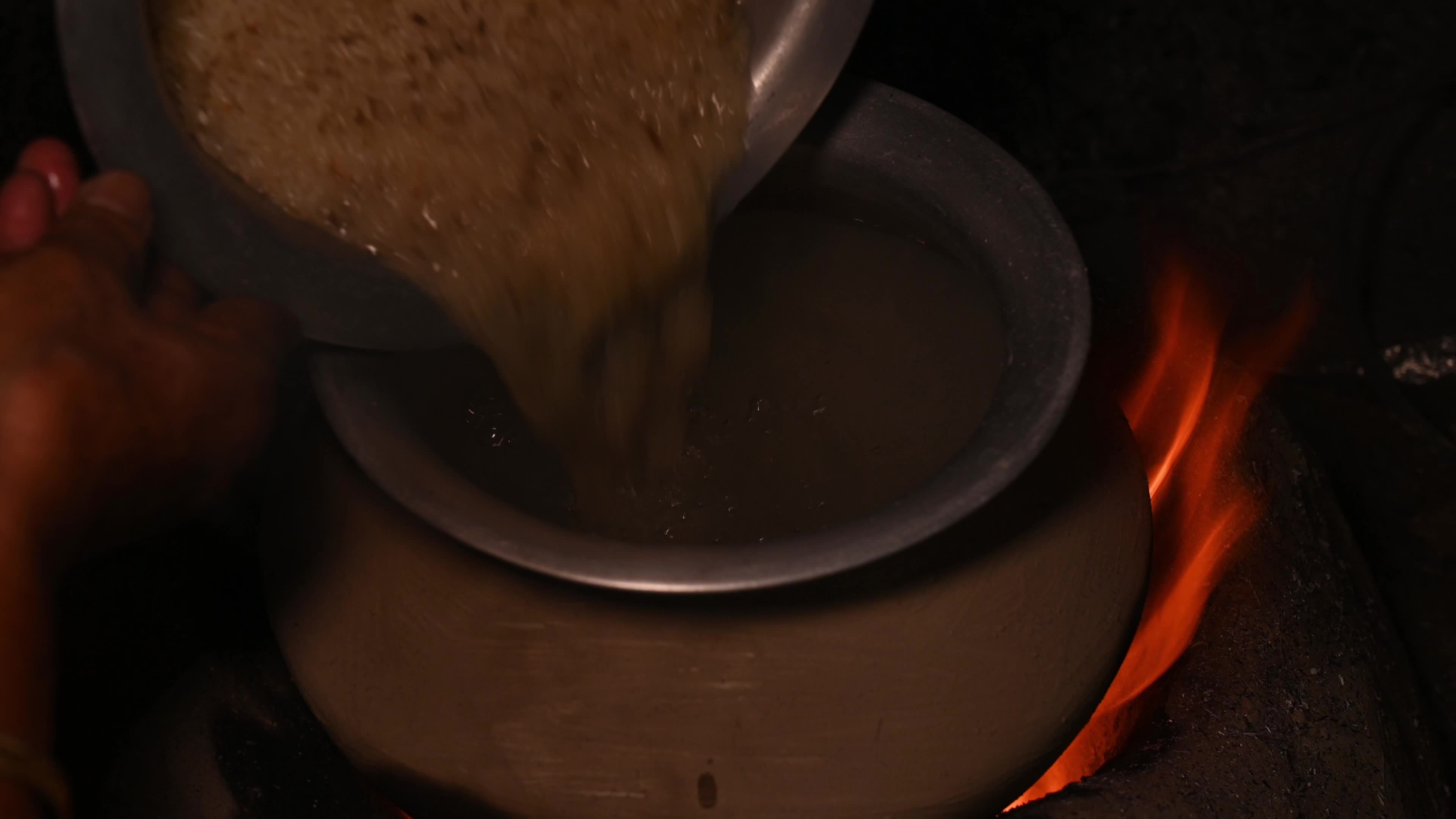Cooking in an Old-fashioned wood-fired mud stove in India 