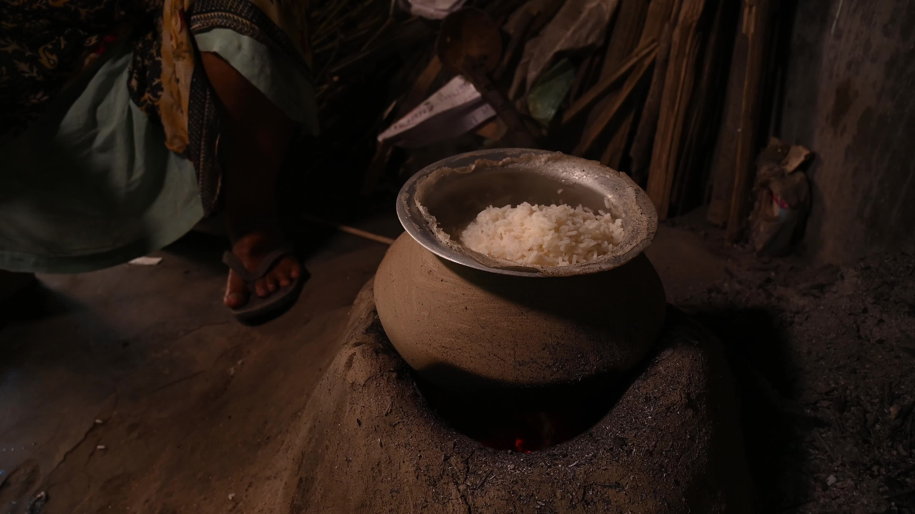 Cooking in an Old-fashioned wood-fired mud stove in India 