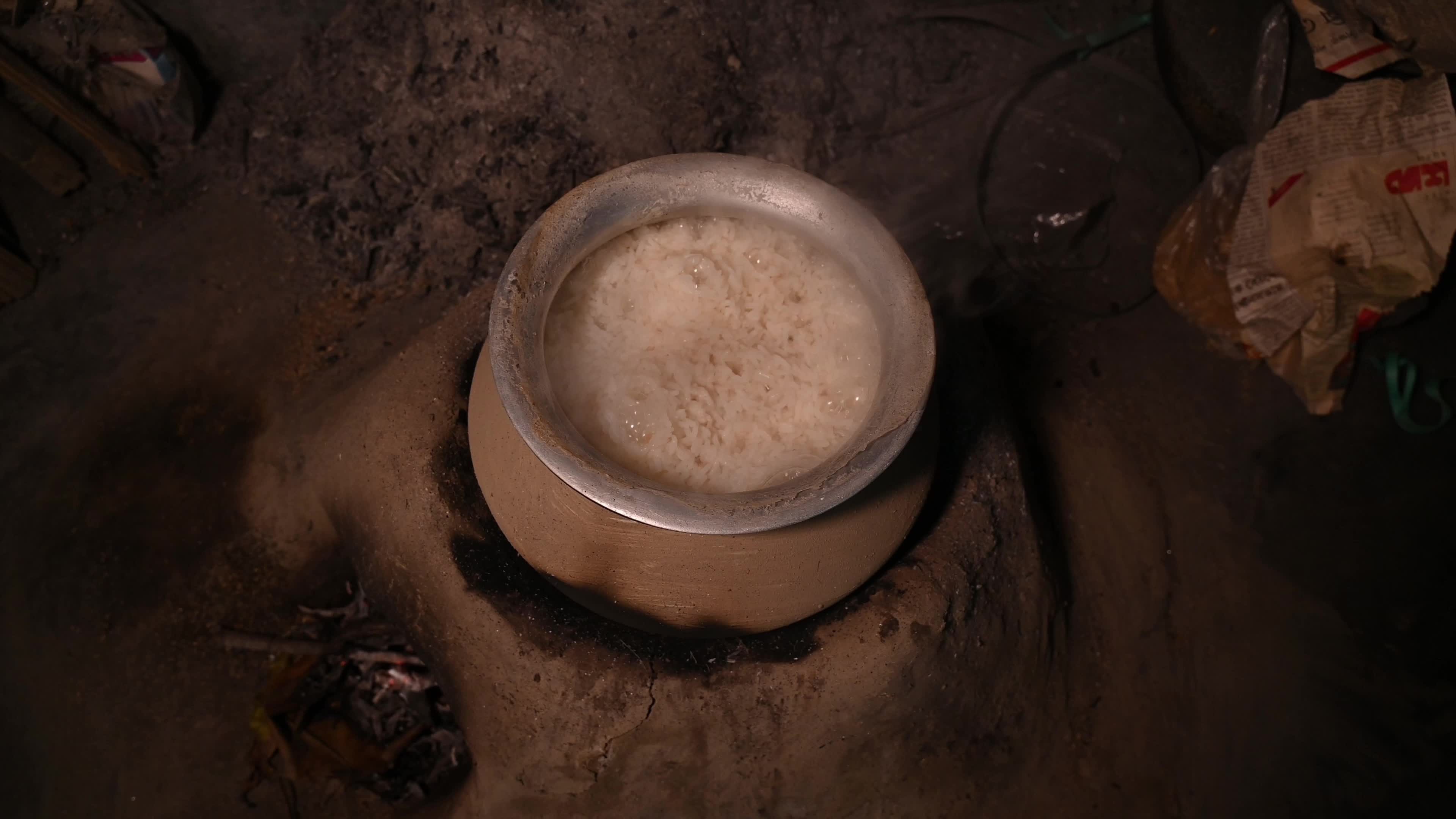 Cooking in an Old-fashioned wood-fired mud stove in India 