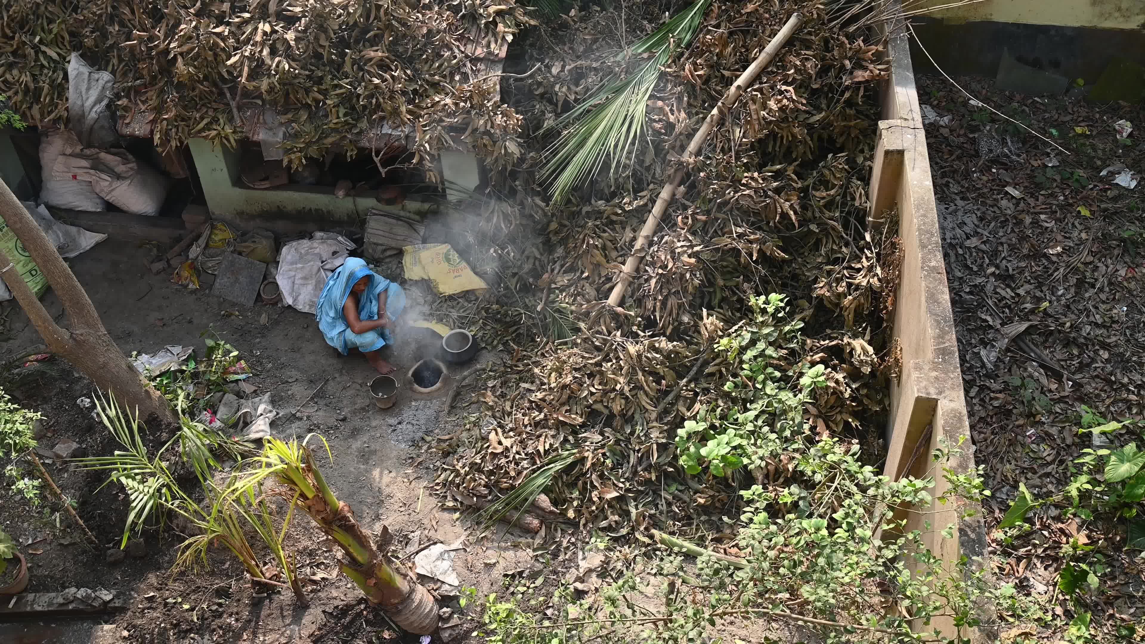 Cooking in an Old-fashioned wood-fired mud stove in India 
