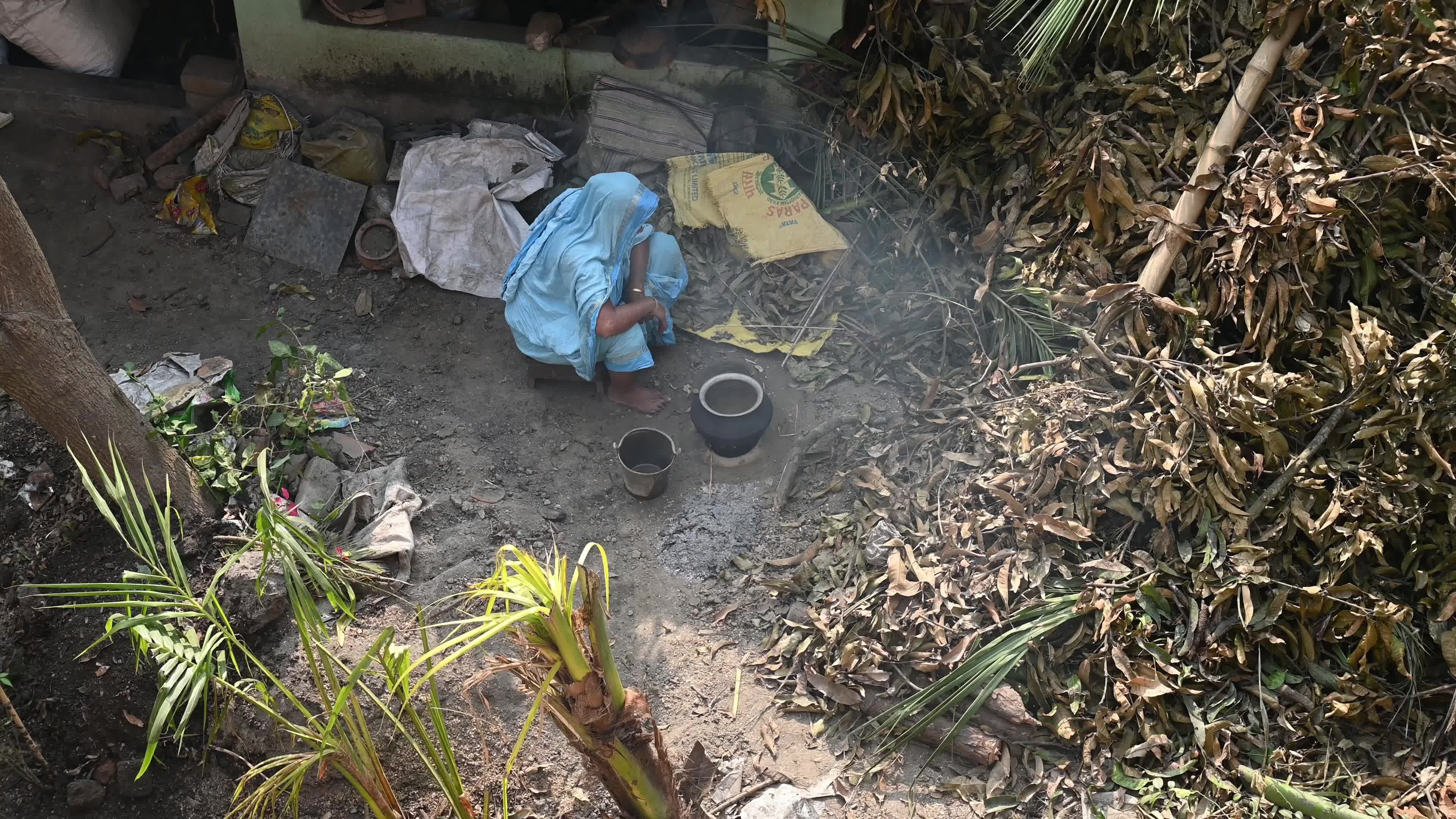 Cooking in an Old-fashioned wood-fired mud stove in India 