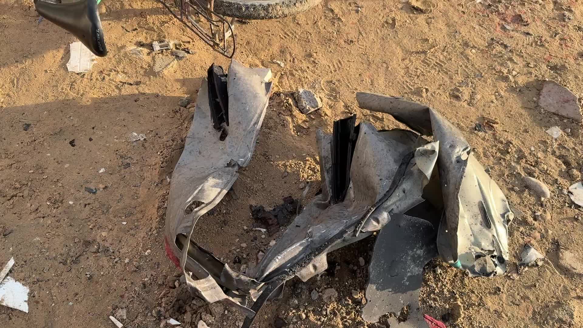 Palestinians Inspect Car After Israeli Strike in Gaza City