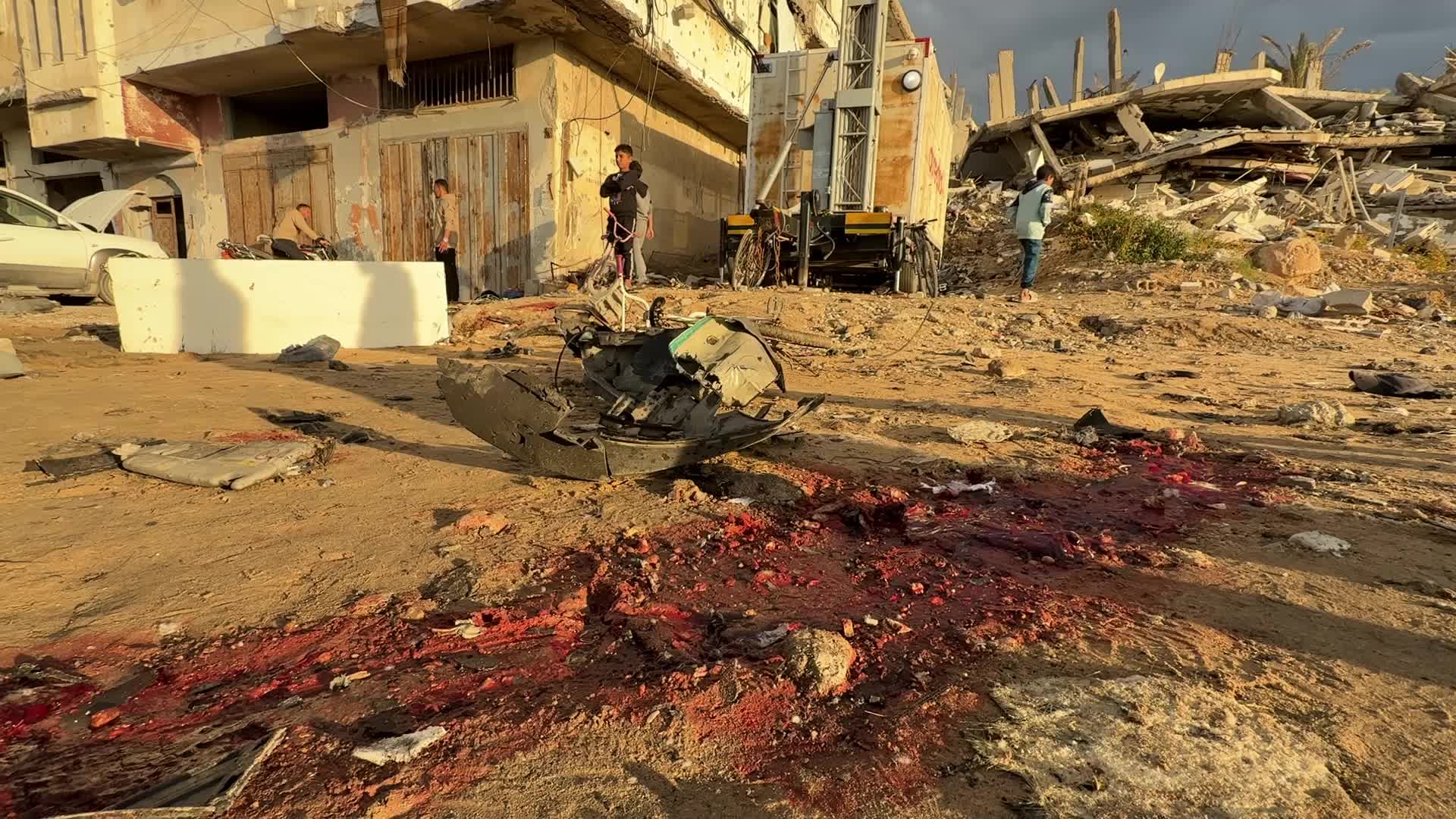 Palestinians Inspect Car After Israeli Strike in Gaza City