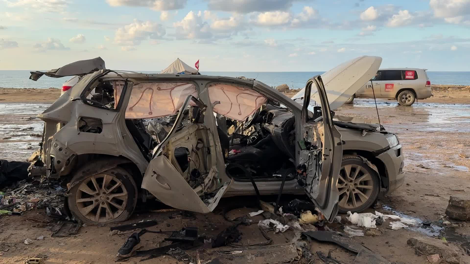 Palestinians Inspect Car After Israeli Strike in Gaza City