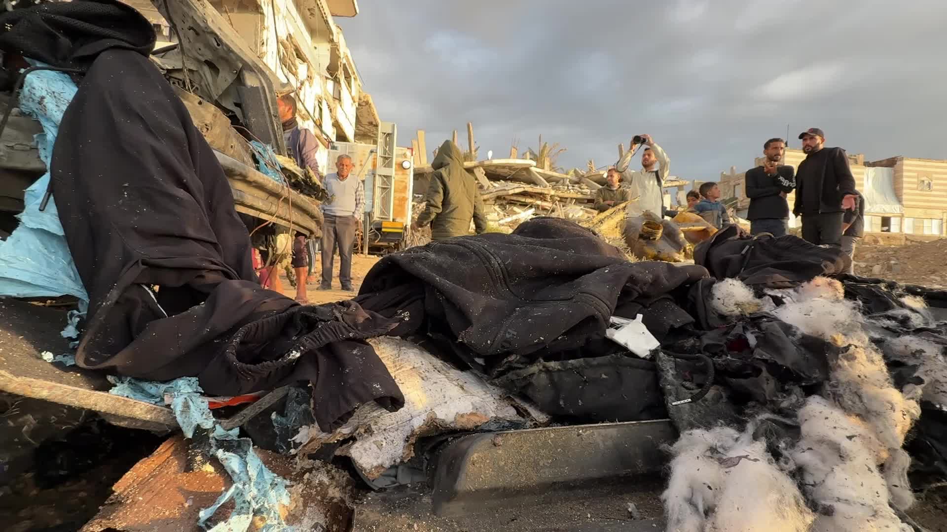 Palestinians Inspect Car After Israeli Strike in Gaza City