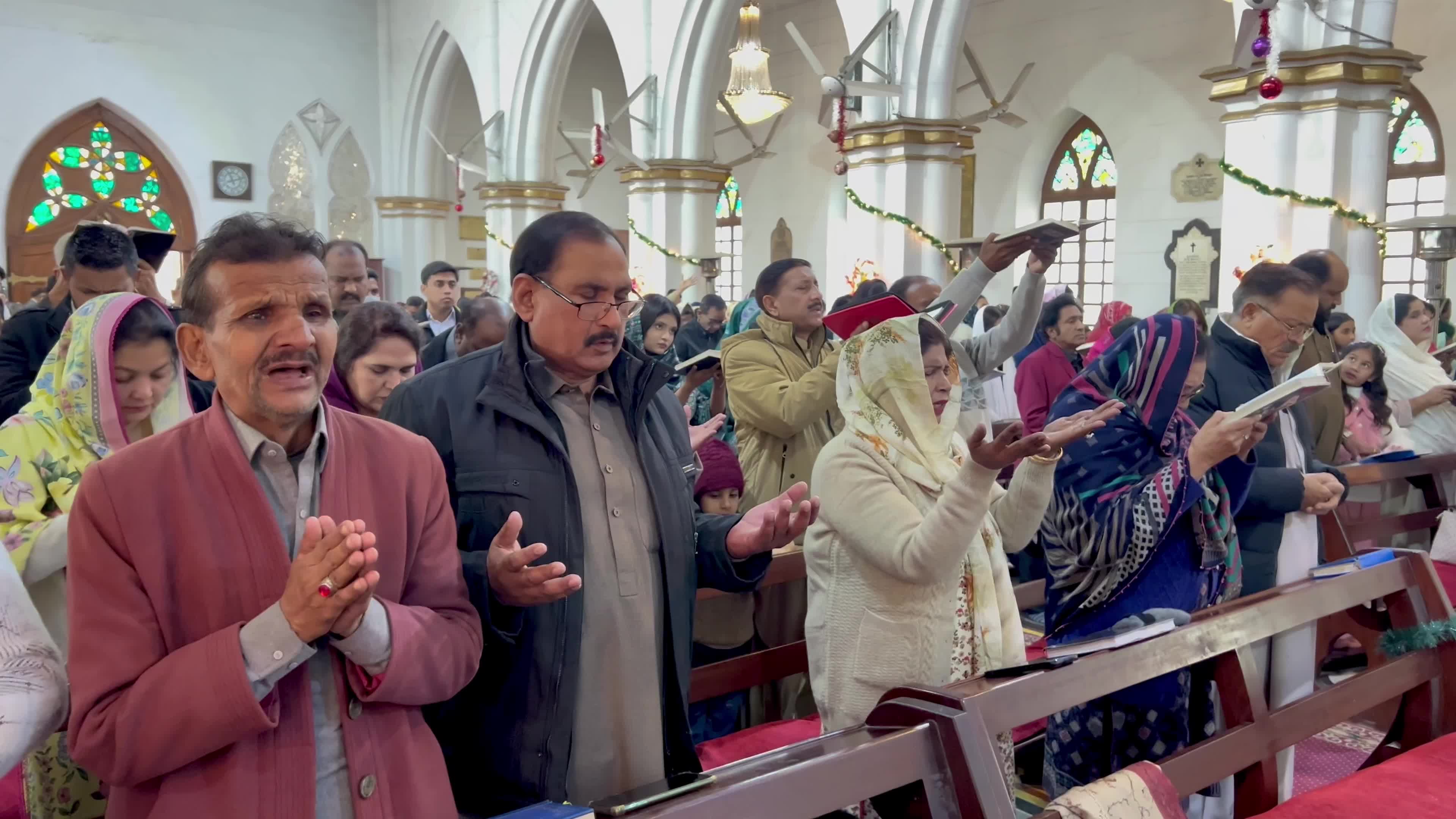 People pray as they attend a New Year service at the St. John's Cathedral in Peshawar 