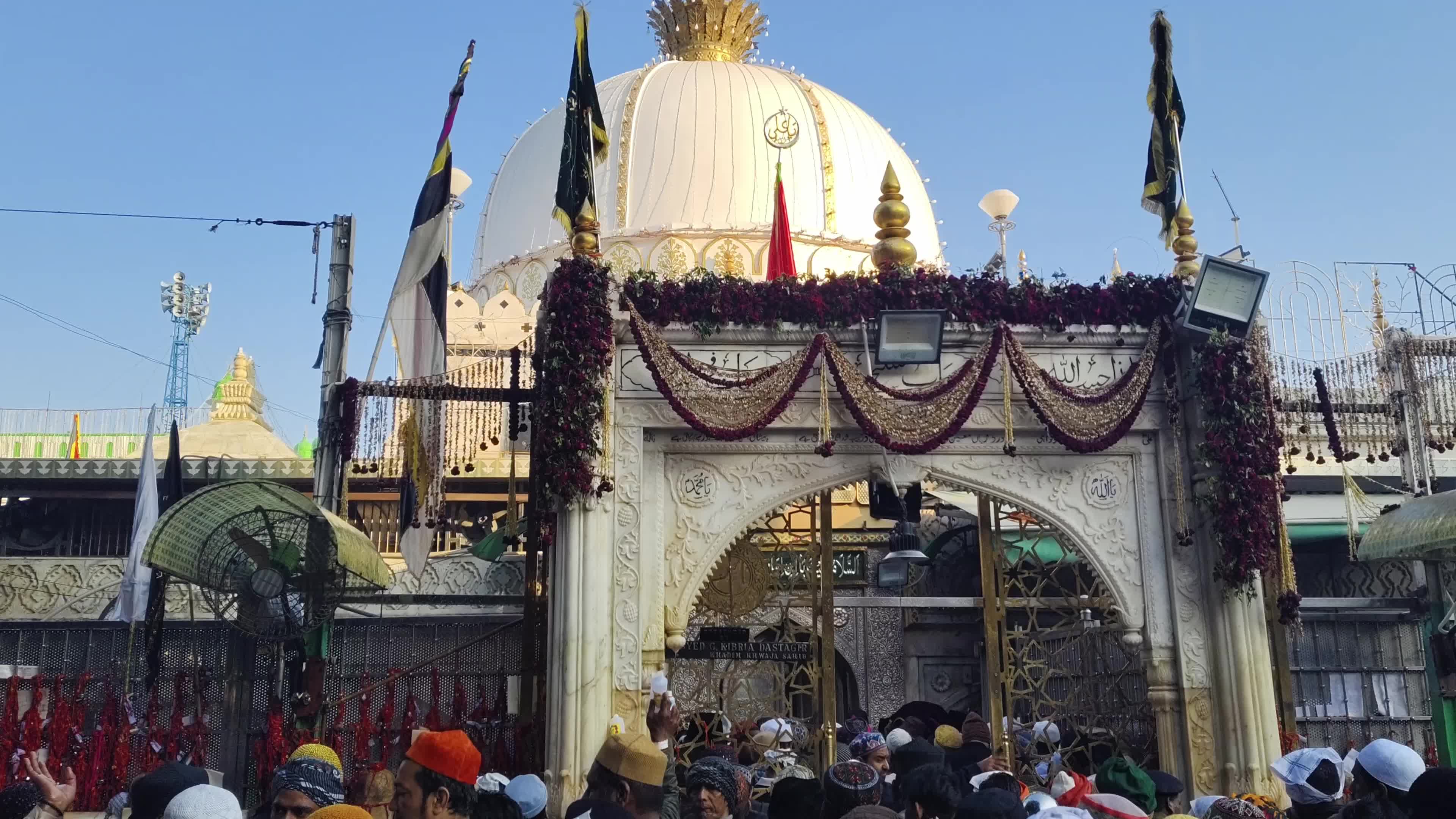 Devotees are showered with perfumed water during the end of the Urs festival