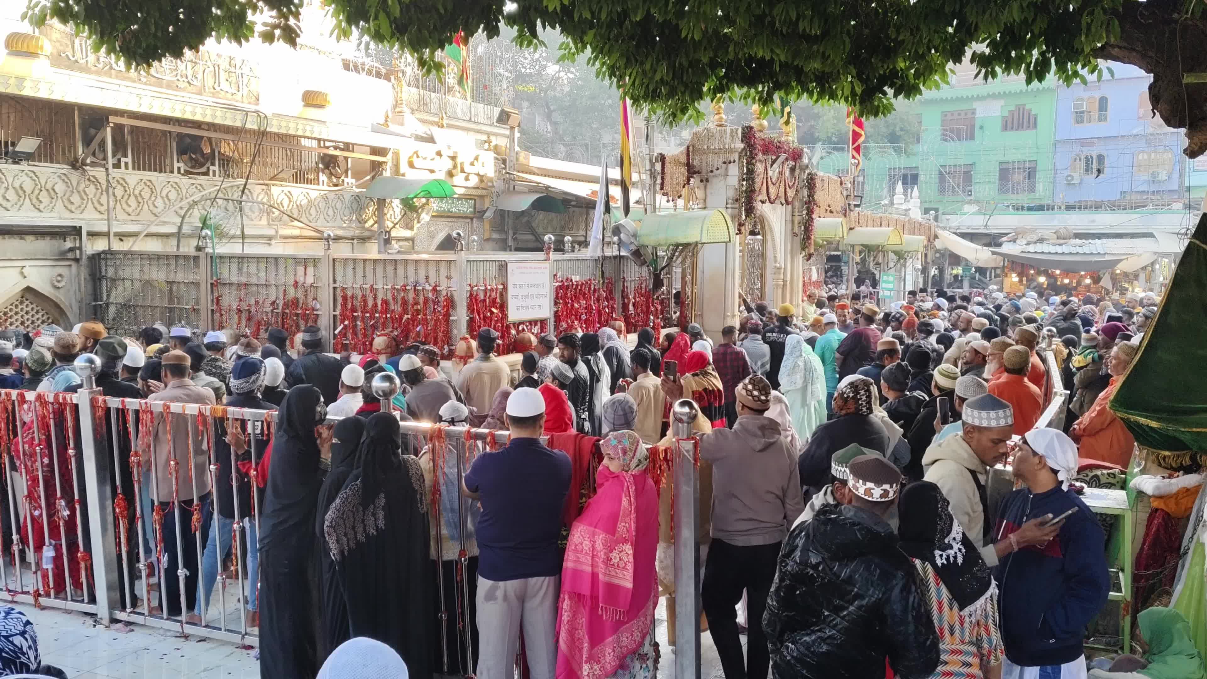 Devotees are showered with perfumed water during the end of the Urs festival