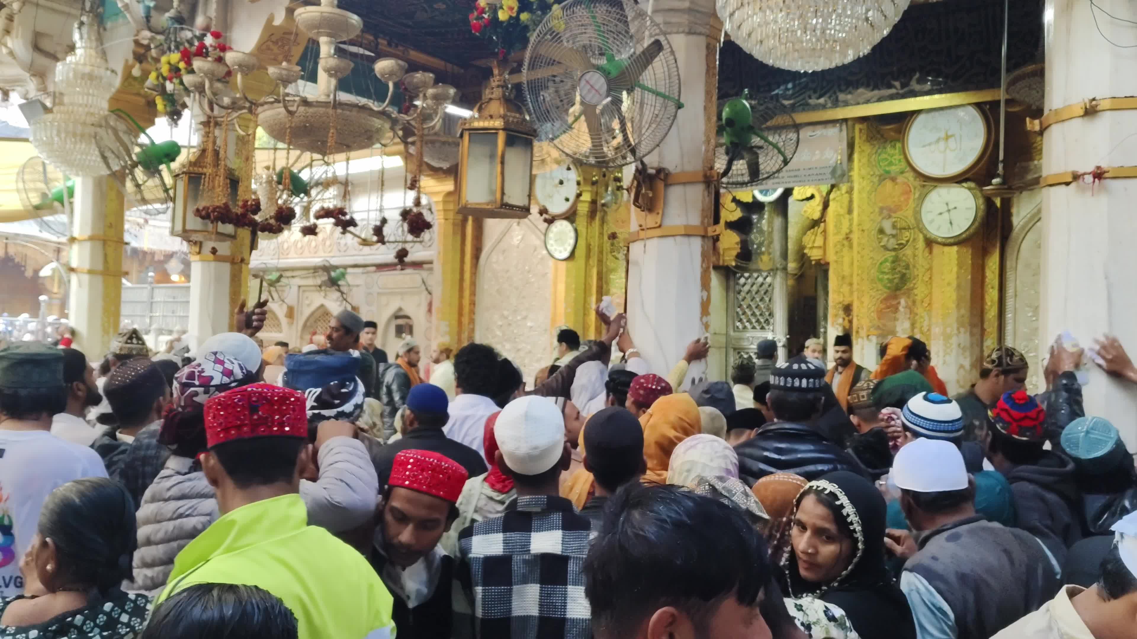 Devotees are showered with perfumed water during the end of the Urs festival