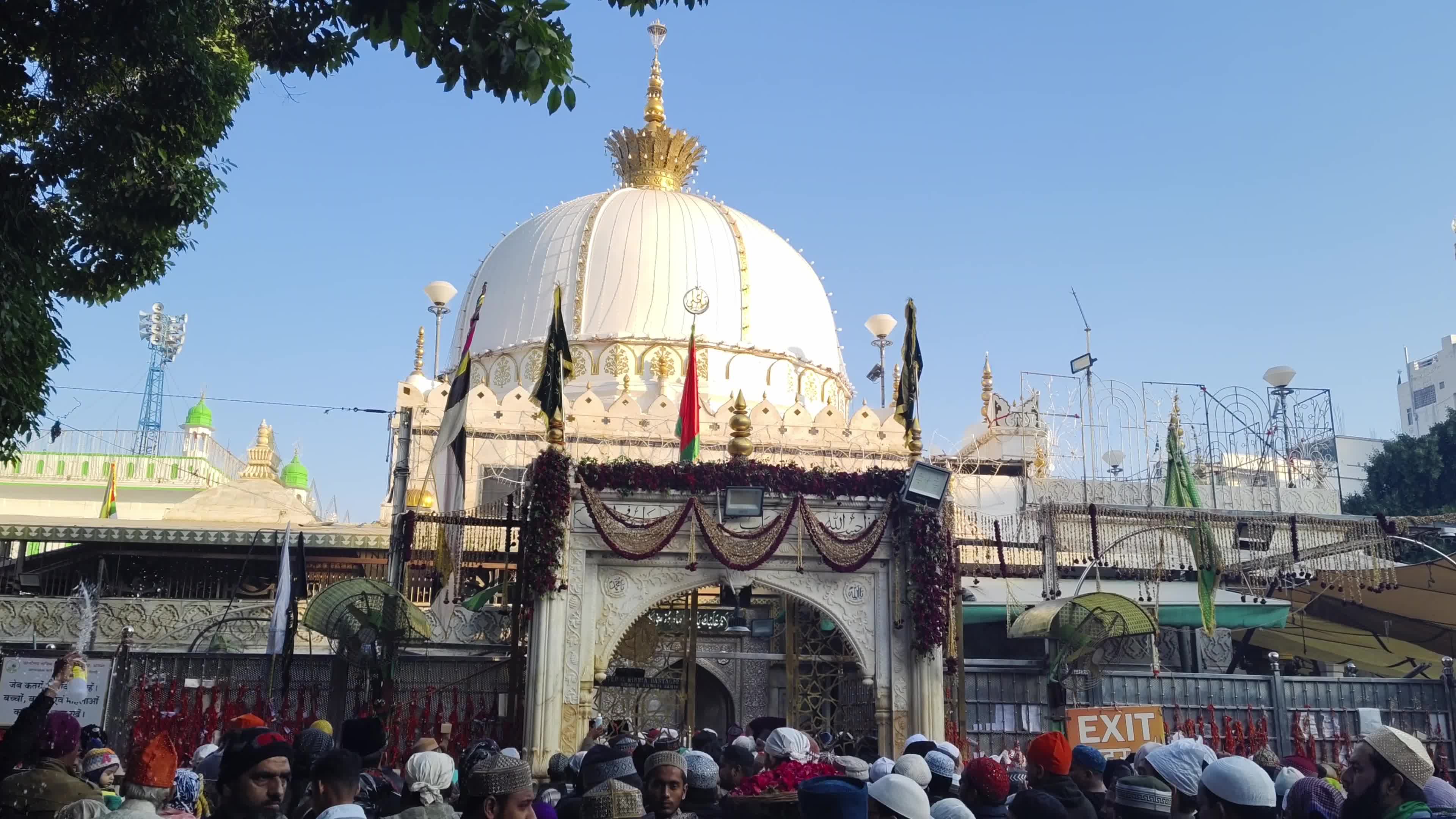 Devotees are showered with perfumed water during the end of the Urs festival