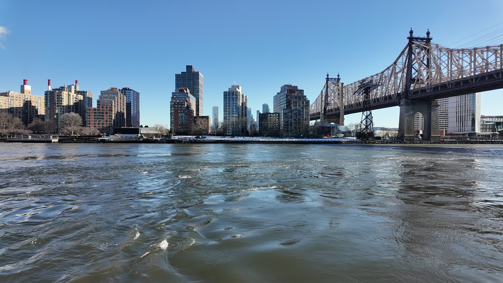 The Queensboro Bridge towers over the East River