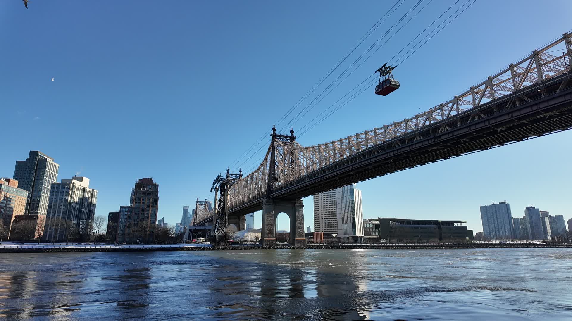 The Queensboro Bridge towers over the East River