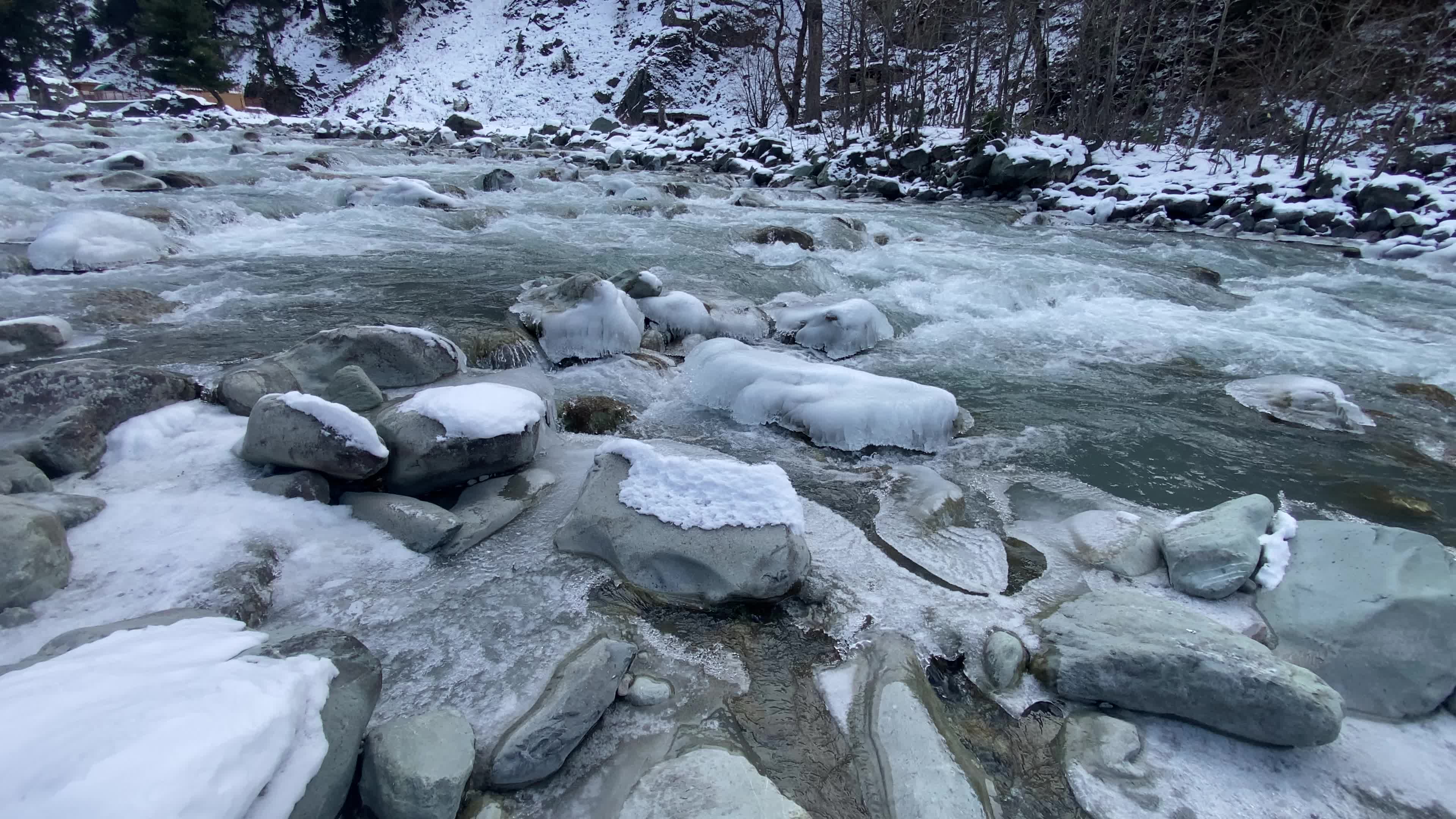 A view of partially frozen river sindh during winter.