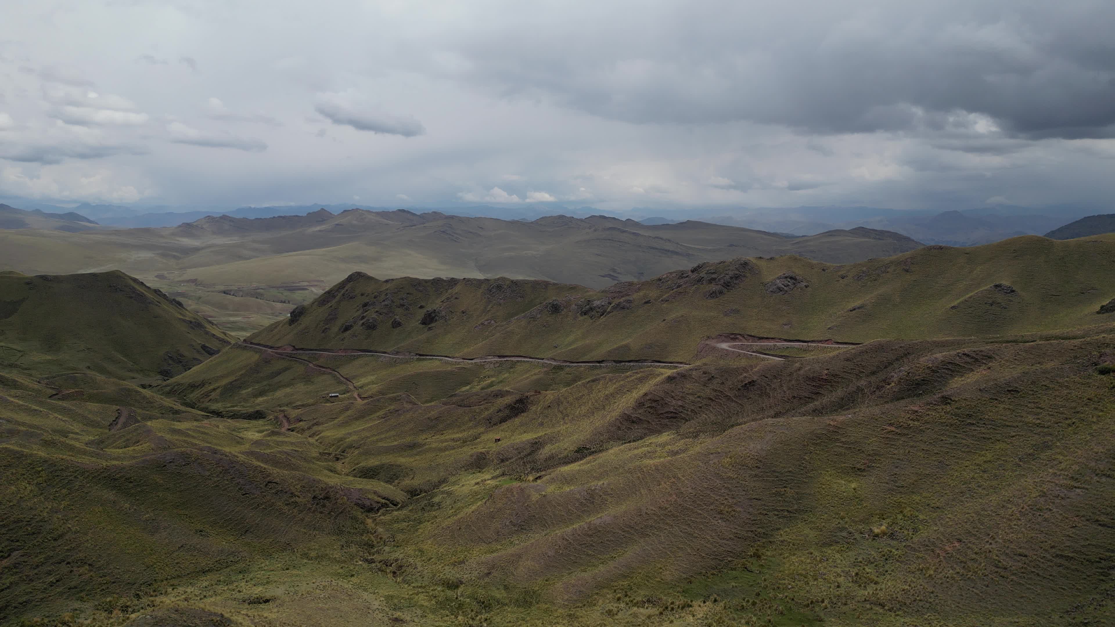 Drone videos of a car driving on the Peruvian Andes