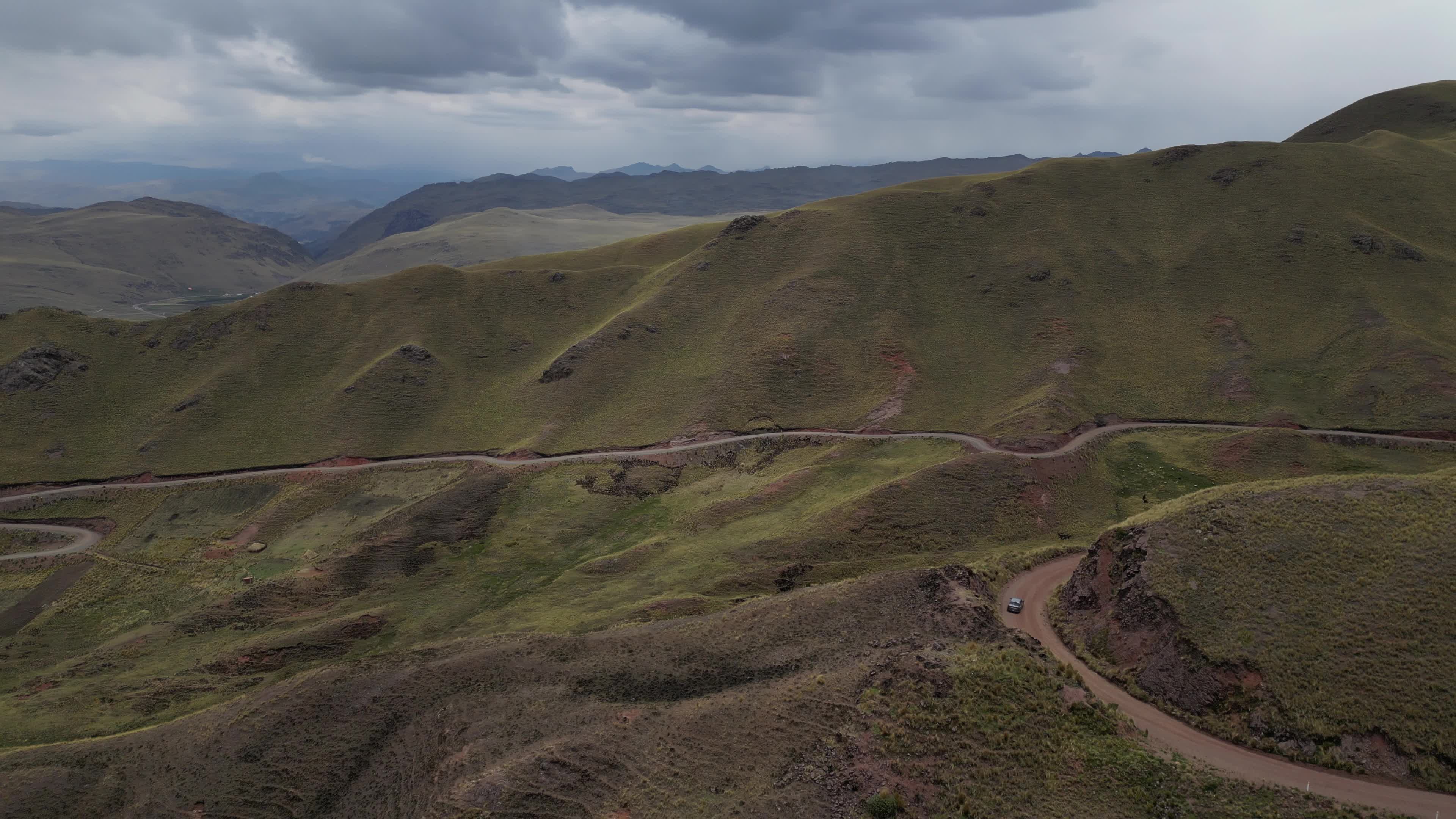 Drone videos of a car driving on the Peruvian Andes
